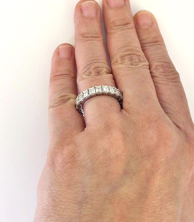 Diamond Emerald Cut Eternity Band Ring in Platinum.
A vintage eternity band comprised of emerald-cut diamonds carefully calibrated and mounted in platinum. Each gemstone is set in a four prong traditional basket which circles throughout the entire
