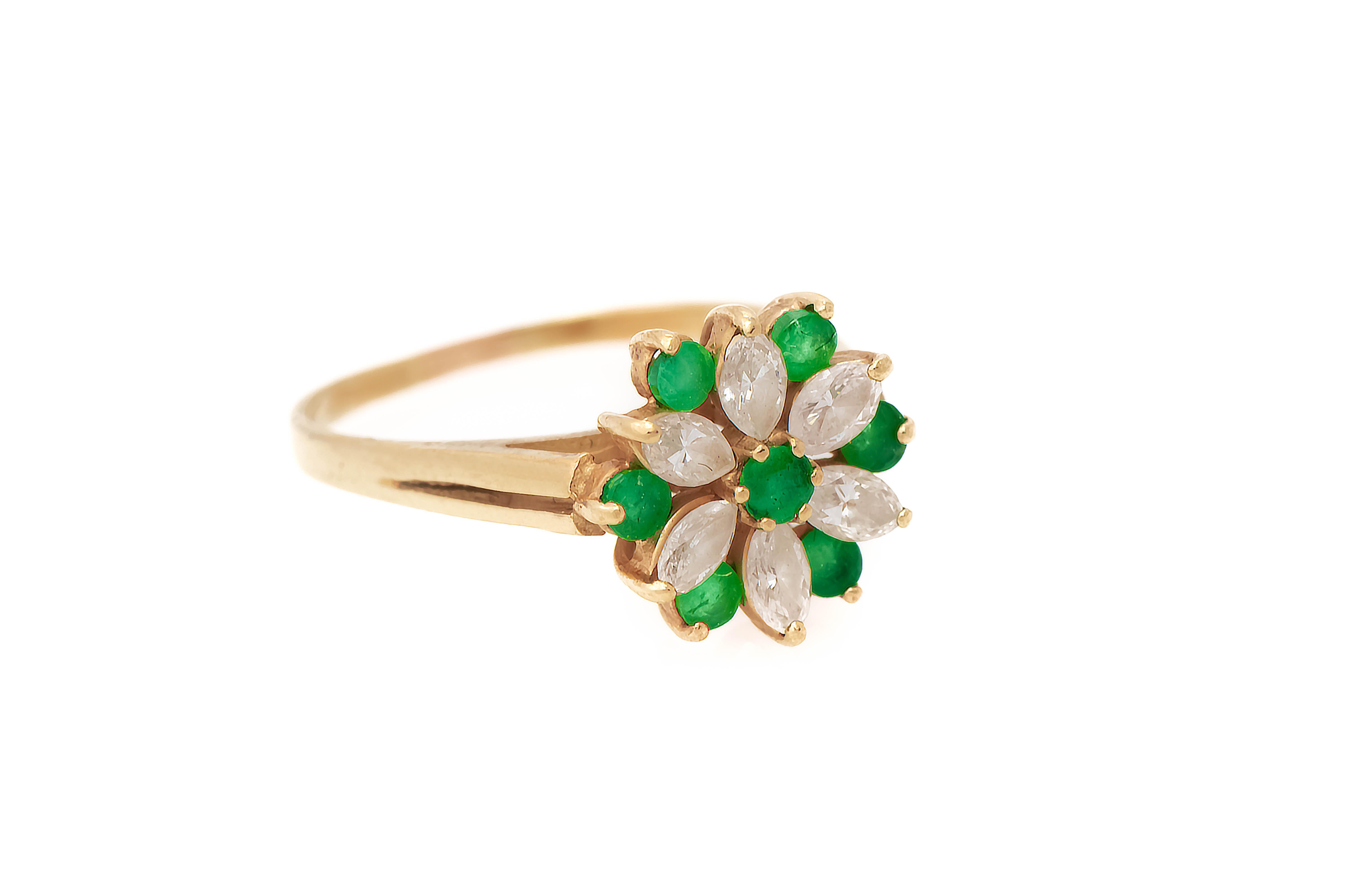 Diamond & Emerald Flower Cocktail Ring 

1 round cut emerald surrounded by 6 marquise cut diamonds & 6 round cut emeralds in a flower motif.

Ring Size: 7.25

Resizable free of charge

Metal Type: 14k yellow gold 
