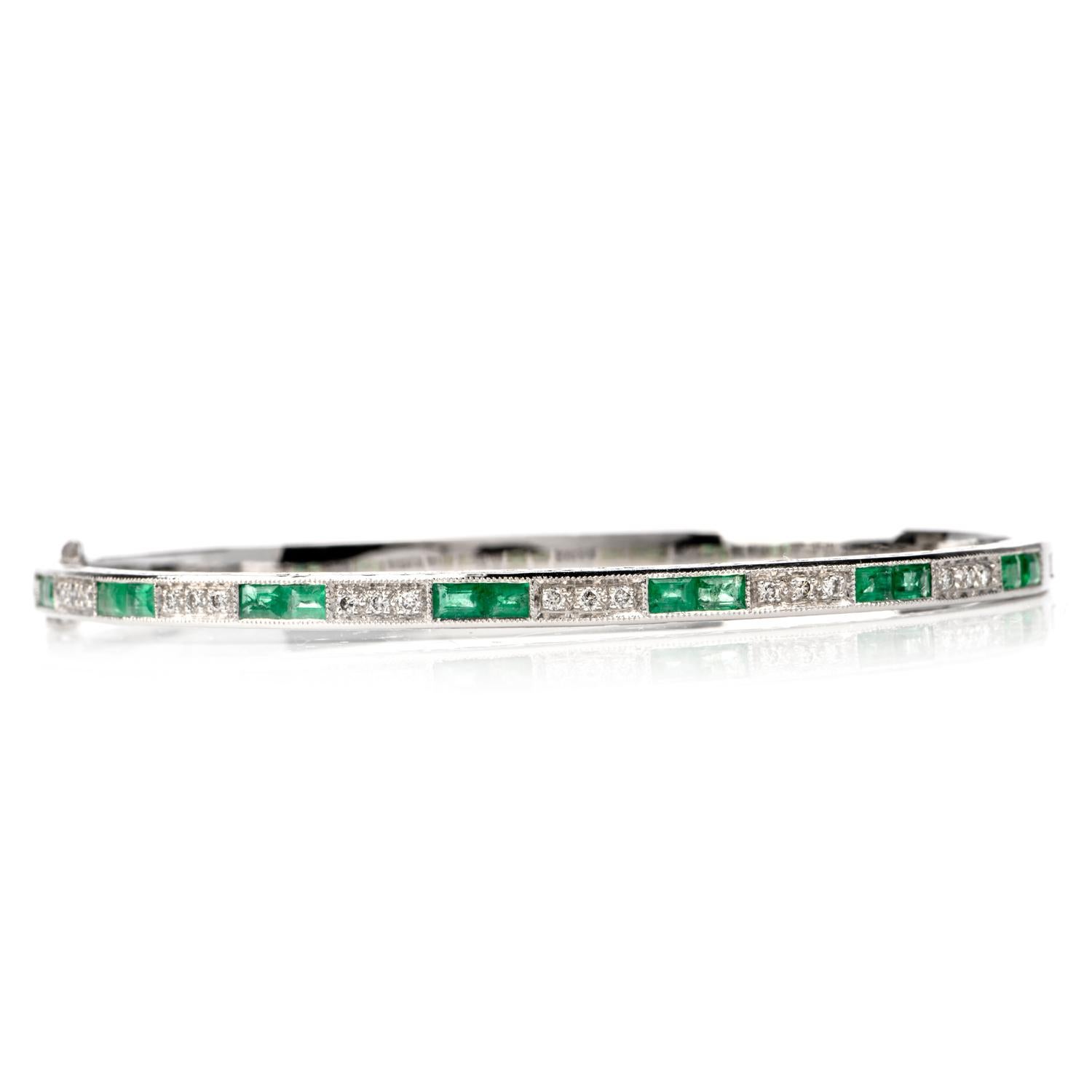 This stunning emerald and diamond bangle bracelet is crafted in 18-karat white gold. Displaying a filigree designed textured gold. Channel-set with 14 emerald-cut genuine emeralds weighing approximately 1.30 carats. Additionally, channel-set with 18