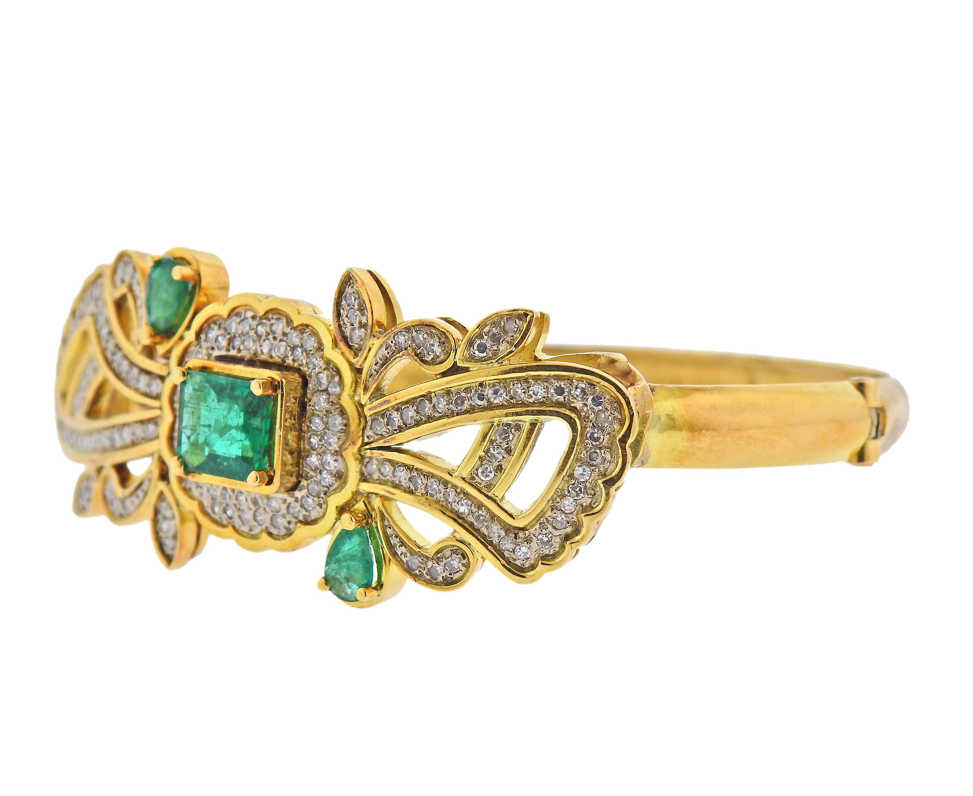 14k yellow gold bangle bracelet , with emeralds and approx. 0.64ctw in diamonds. Bracelet will fit approx. 7