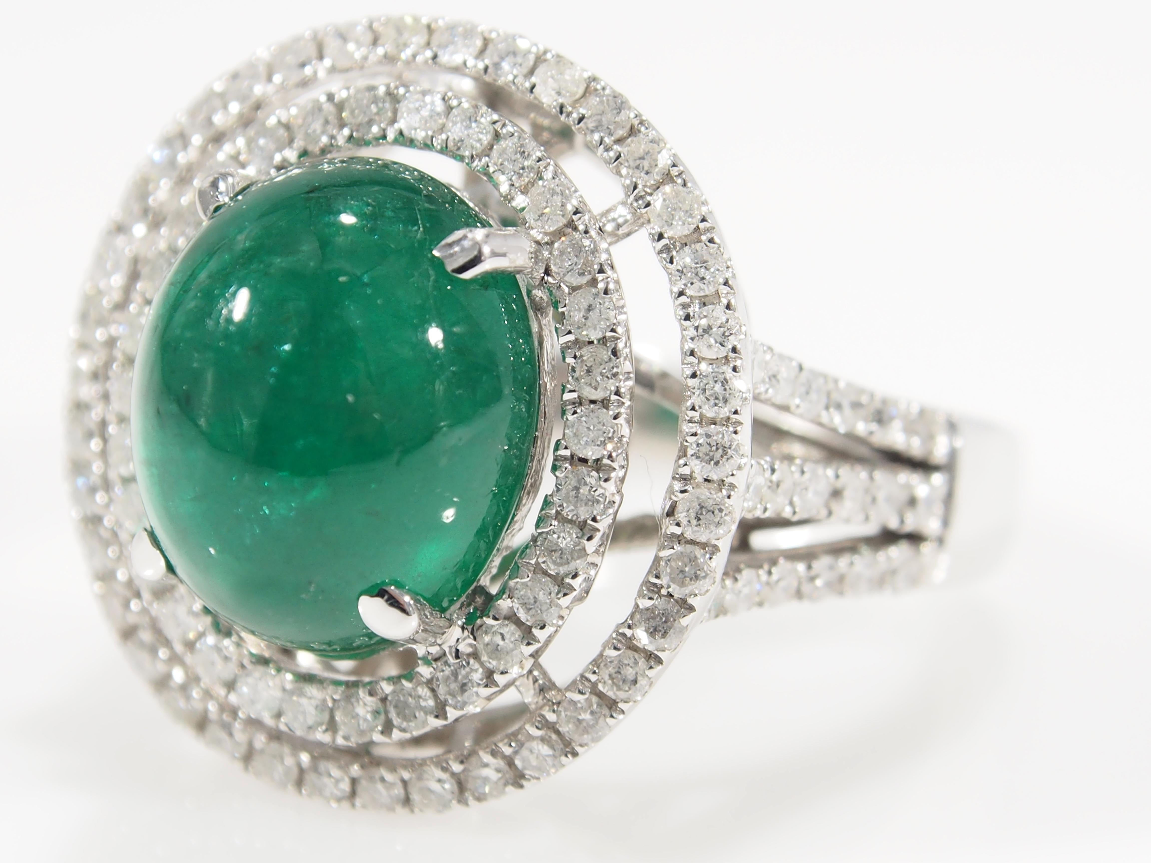 For the jewelry lover that appreciates Emeralds is this striking 6.10 Carat. Emerald Cabochon Ring. Fashioned in 14 Karat White Gold with a double Halo of 104 Round Brilliant Cut Diamonds, approximately 1.04 Carat, G-J in Color, SI to I1 in Clarity