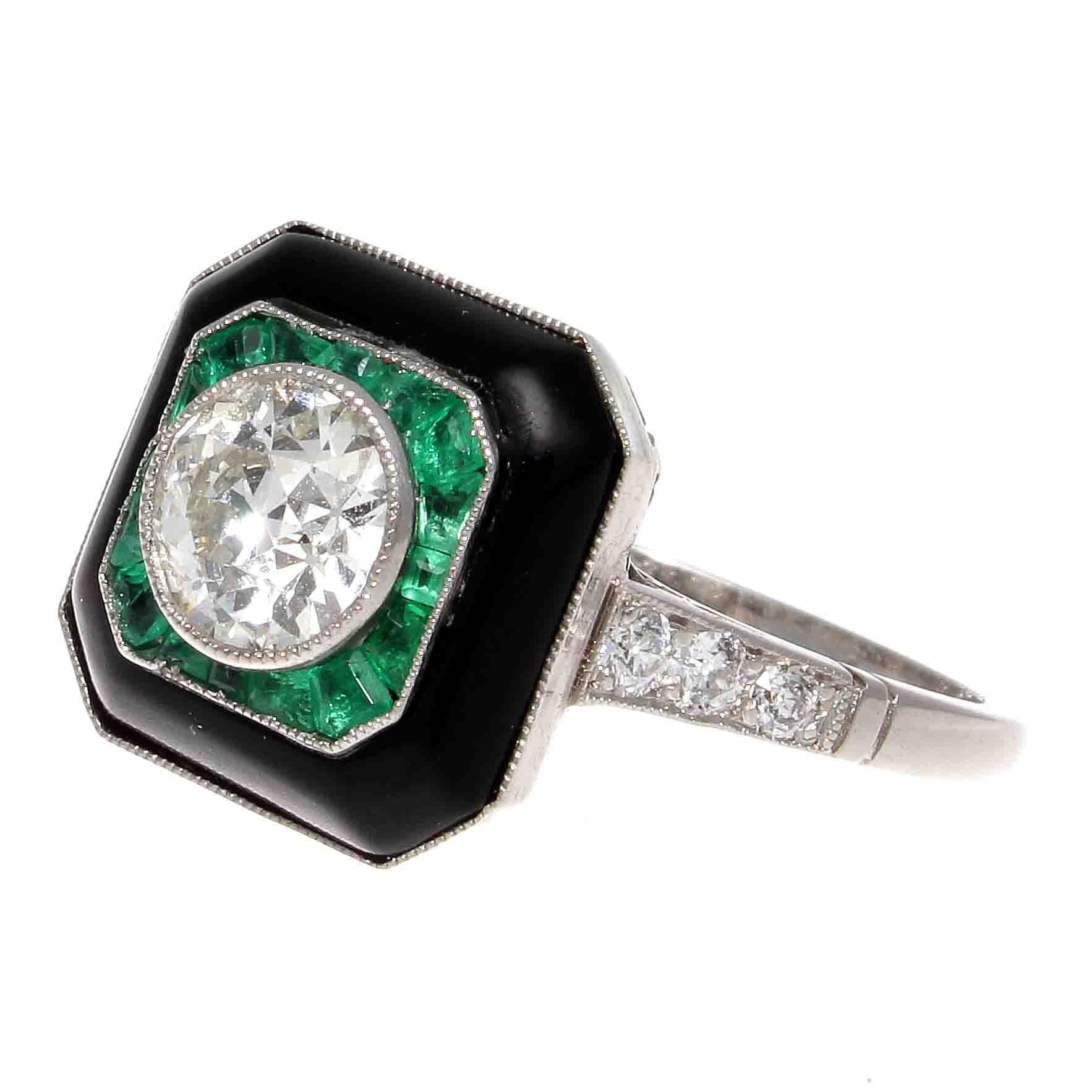 Sumptuous color and design to reinvigorate the Art Deco style of old to new. Featuring a 0.87 carat old European cut diamond that is I color, SI1 clarity. Wrapped in layers of glowing green emeralds and jet black onyx. Hand crafted in