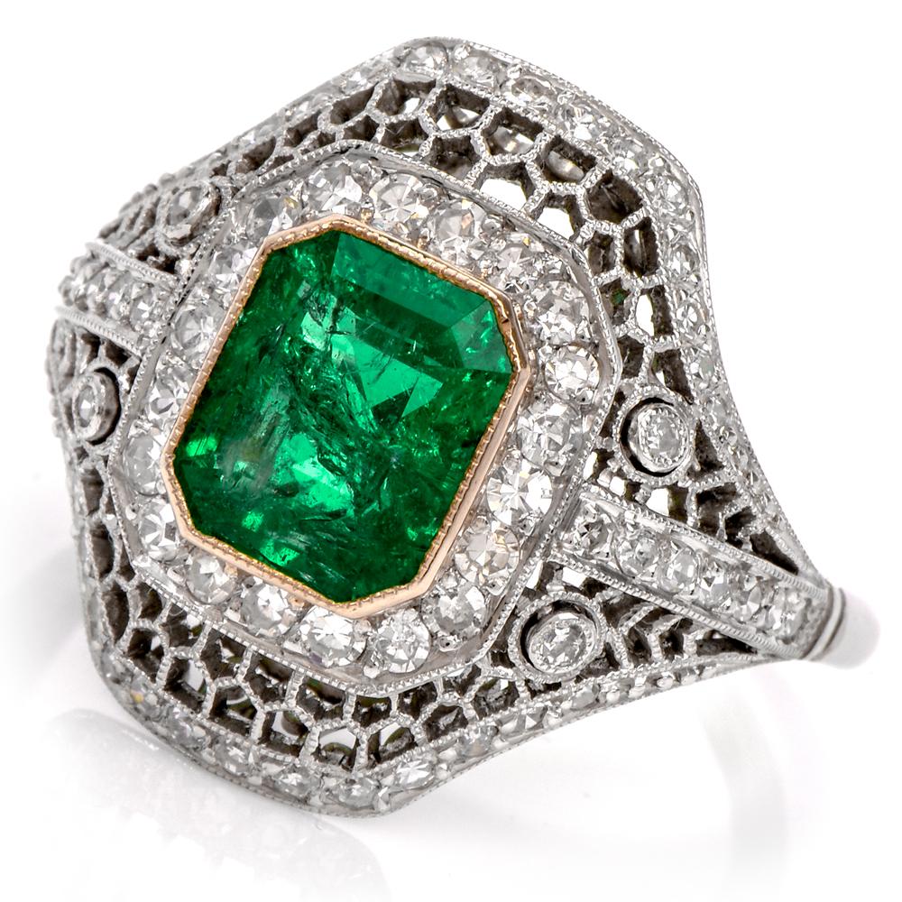 This diamond and emerald filigree ring is crafted in solid platinum. Showcasing a centered emerald-cut genuine Colombian emerald weighing approx. 1.50 carats. Surrounded by an open work frame set exquisitely with 66 round cut diamonds weighing
