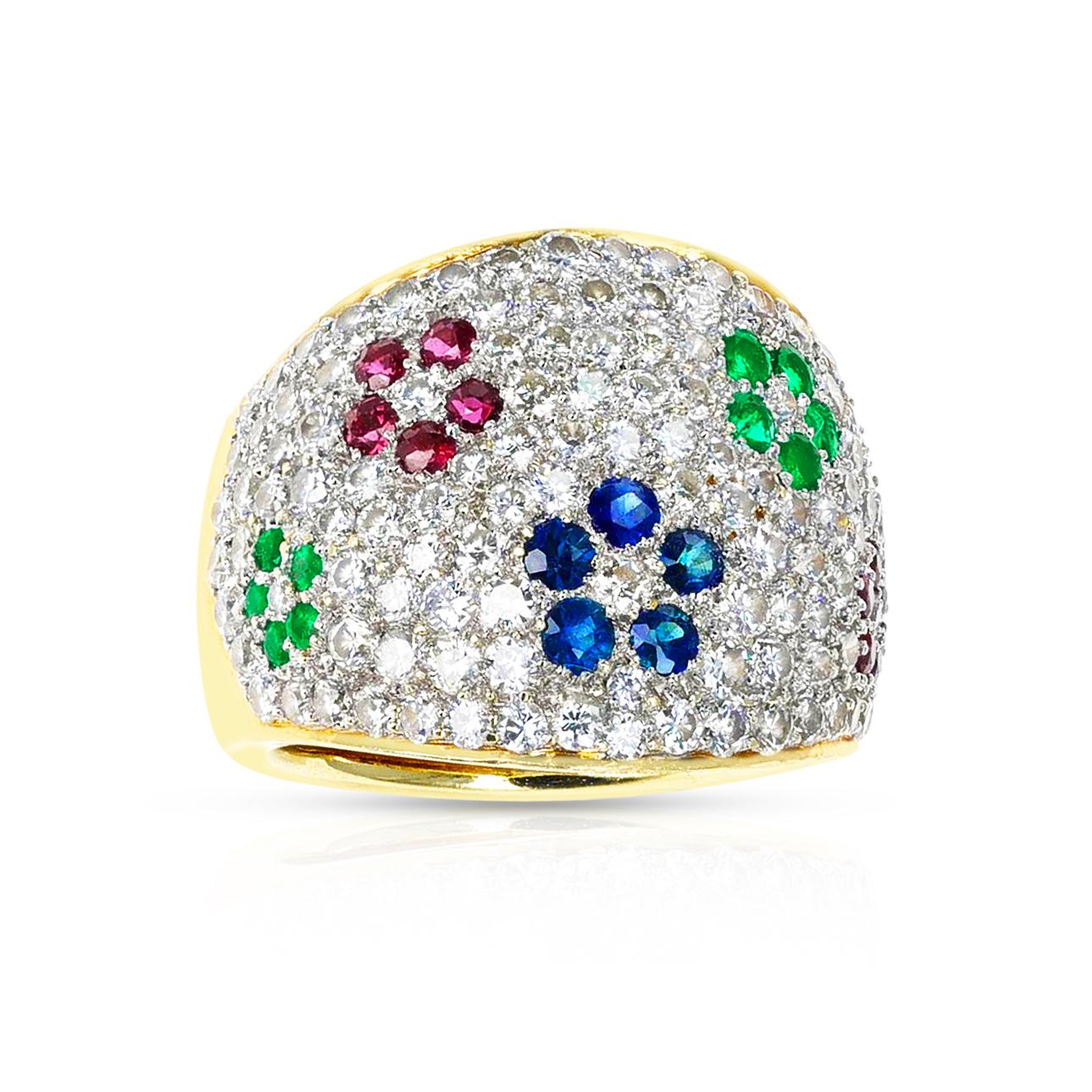 A Diamond, Emerald, Ruby and Sapphire Floral Design Cocktail Ring made in 18 Karat Yellow Gold. The diamonds weigh appx. 2.25 carats. The total weight of the ring is 19.96 grams. The ring size is 5.75 US. Matching earrings available. 