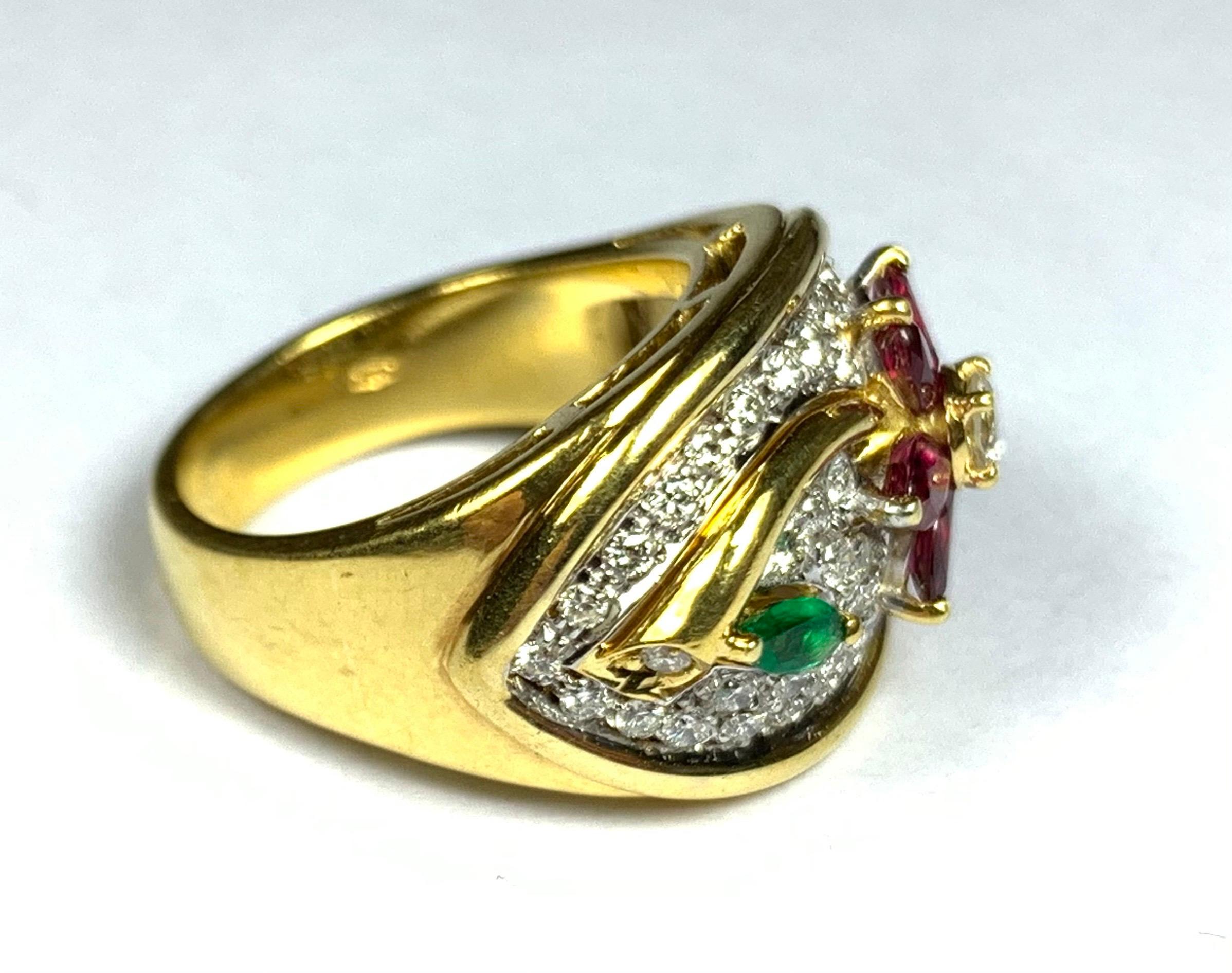 A striking 18ct yellow gold ring designed as a flower, set with diamonds, rubies and an emerald. Can be sized. Ring size 5 1/8.