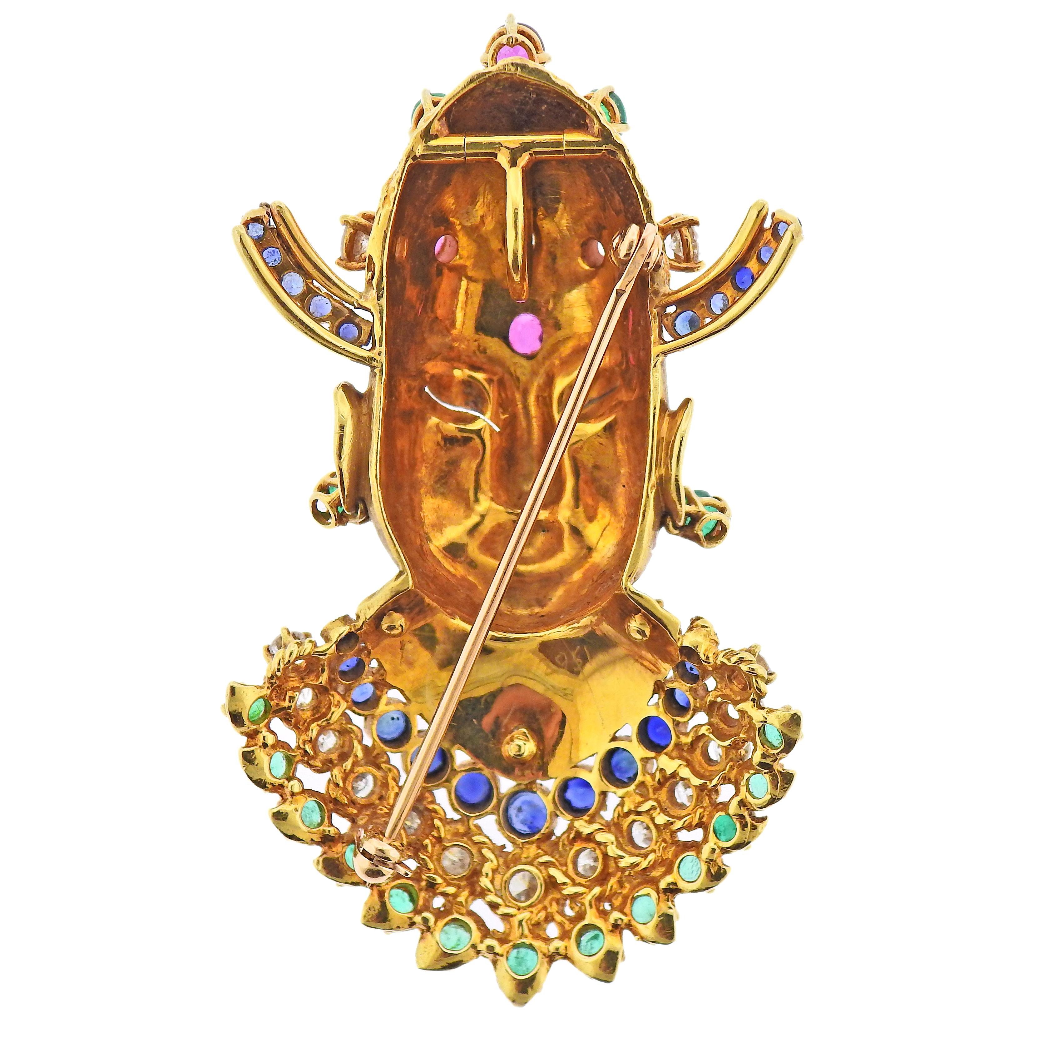 18k yellow gold brooch/pendant, set with emeralds, rubies, sapphires and approx. 3.25ctw in diamonds. Brooch is 67mm x 40mm. Marked with a scratched serial number 2951. Weight - 43.7 grams. 