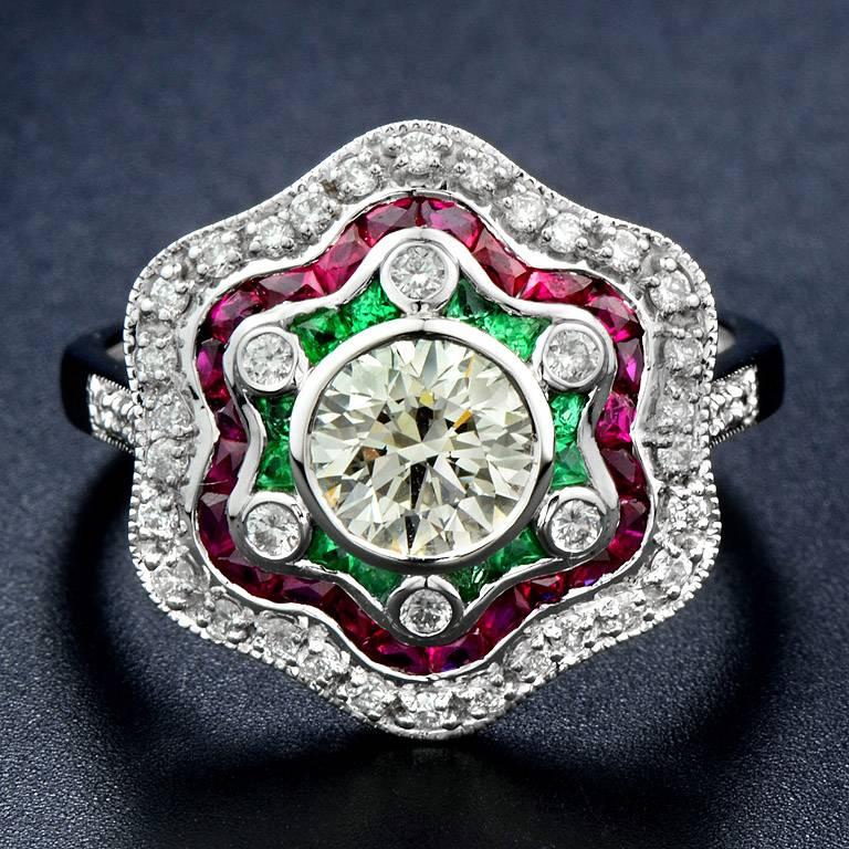 0.815 Carat Diamond J Color VS1 Clarity Set in the center. The halo was set with Emerald 12 pieces 0.18 Carat Separated by Diamond 6 pieces 0.09 Carat and Ruby 24 pieces 1.25 Carat Surrounded by 36 pieces 0.23 Carat Diamond.

The Ring was made in