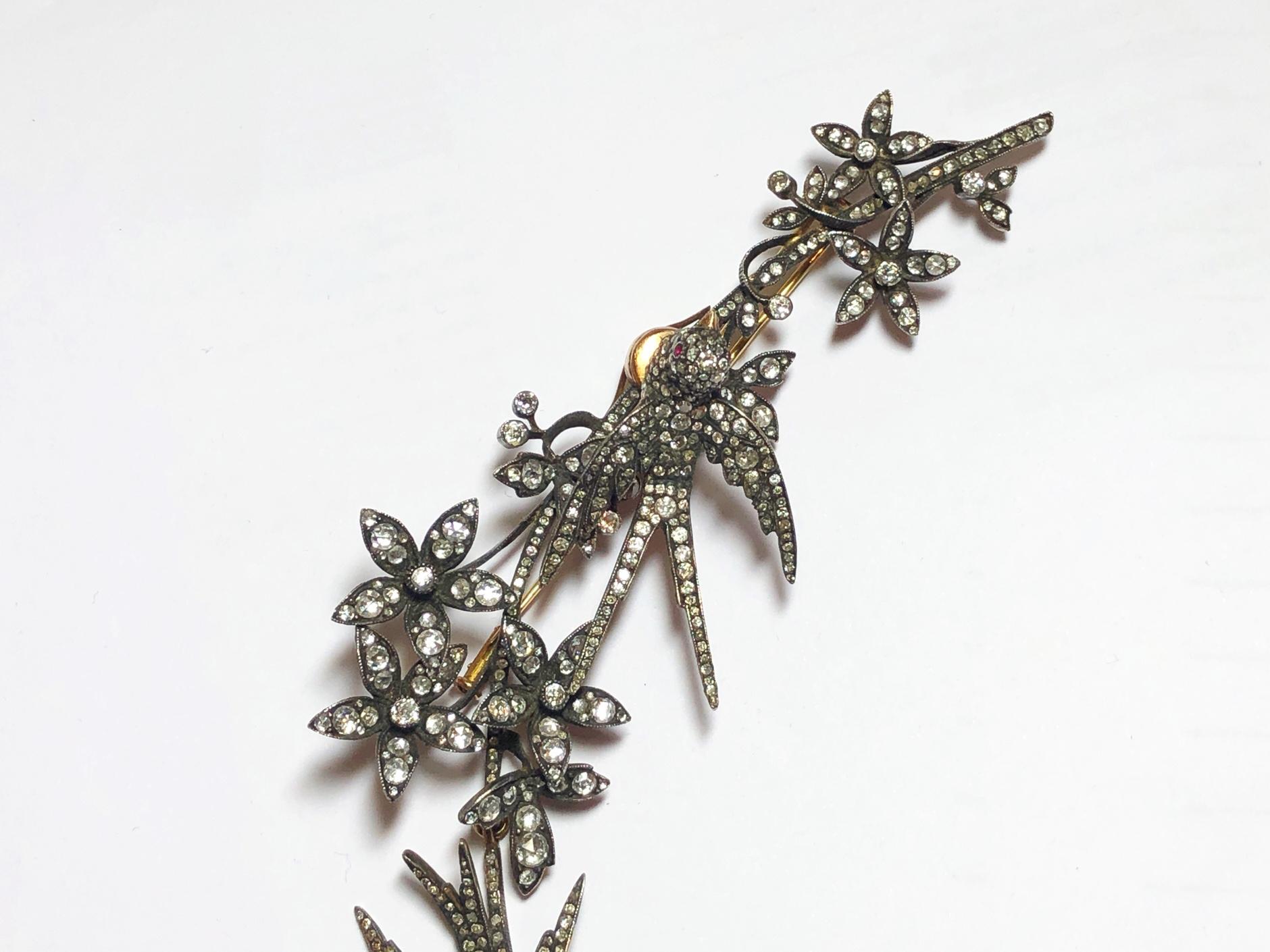 Silver-upon-gold, long trembling bird and flower brooch, set with 14.66ct of old-cut, rose-cut and round brilliant-cut diamonds.
