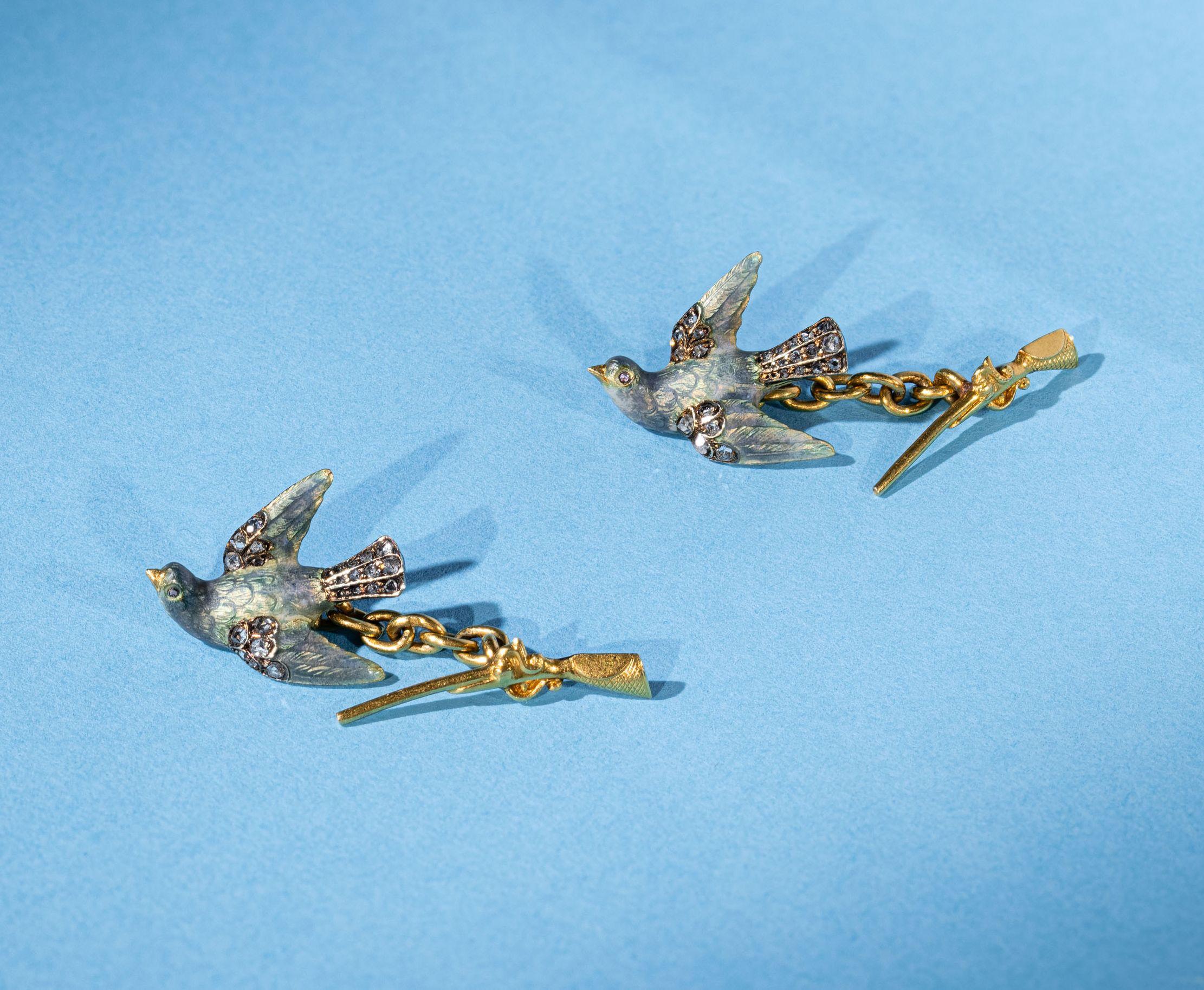 Dazzling pair of golden cufflinks designed as a turtle dove, applied with enamel and rose cut diamonds, the backs modelled as a shotgun. 
Early 20th century, French import assay marks. Early 20th century,
The delicately crafted, beautiful cufflinks