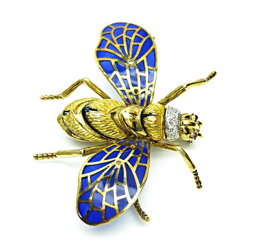 This is an adorable 18k yellow and white gold enamel plique-a-jour bee pin. The pin is adorned with round cut diamond and ruby accents. The pin measures 52mm by 72mm and weighs 34 grams. The pin is stamped ITALY 18K.