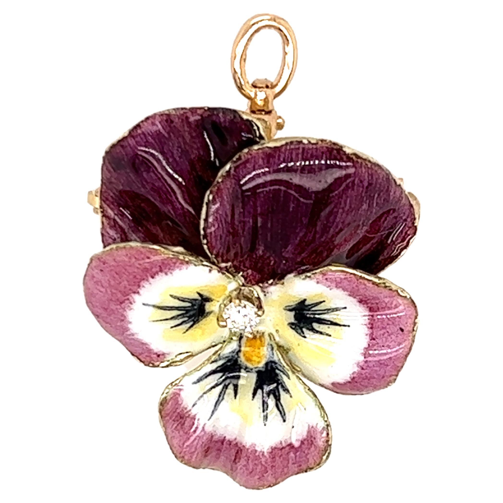 One 14-karat yellow gold pansy design convertible pendant/brooch with purple and white enamel set with one round brilliant cut diamond, approximately 0.30-carat total weight with I/J color and SI1 clarity.  The pendant measures one inch and is