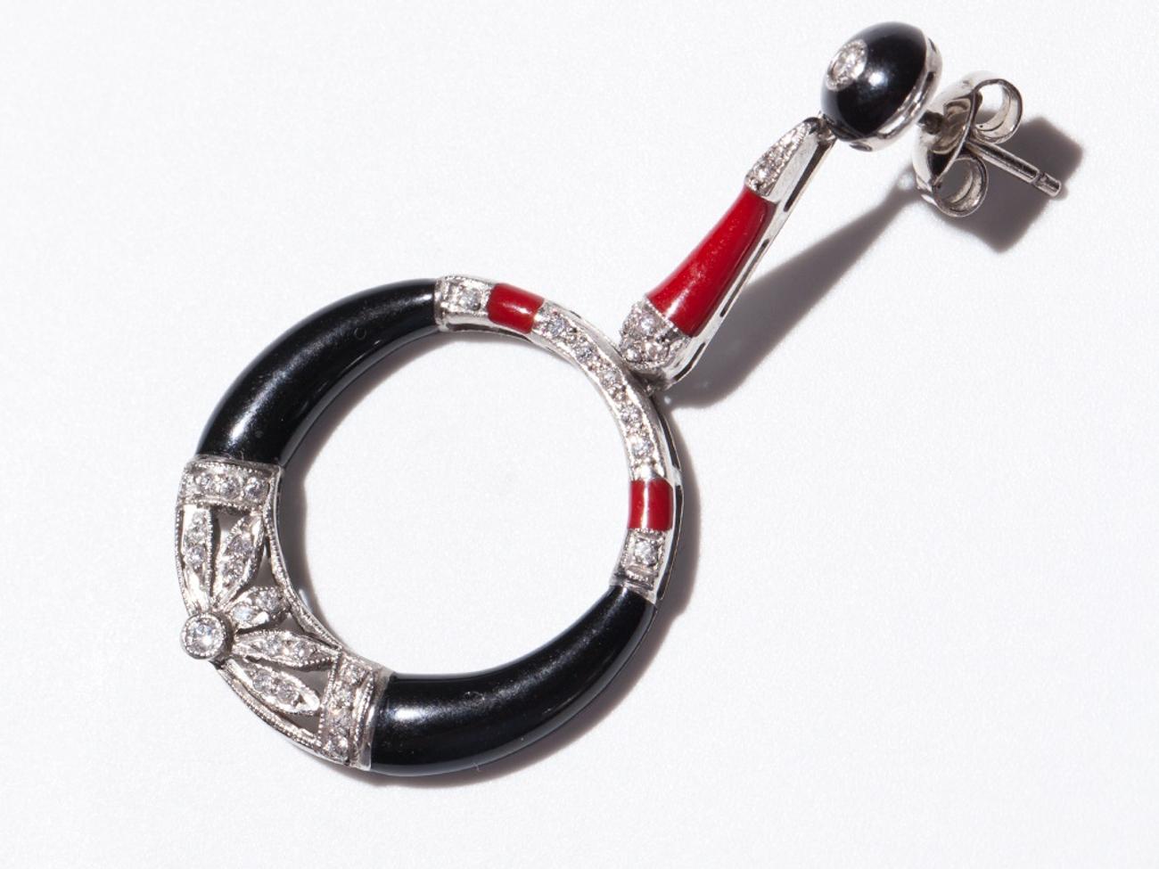 Diese Platin-Ohrringe mit roter und schwarzer Emaille und Diamanten bestechen durch ihr ungewöhnliches Design. Die 66 Diamanten im Altminenschliff mit einem Gesamtgewicht von ca. 0,6 Karat leuchten und funkeln vor der kontrastreichen roten und