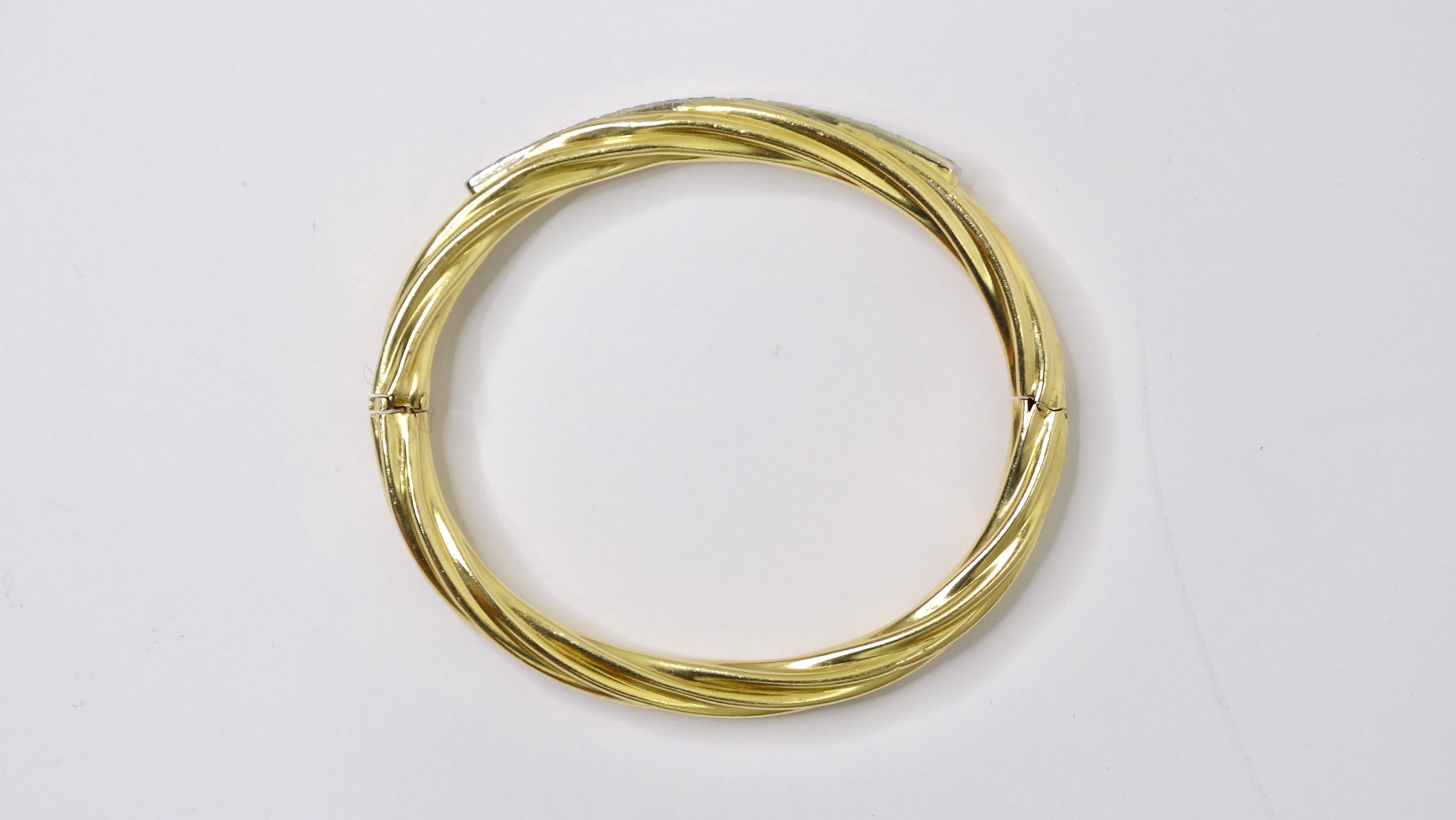 A beautifully done bracelet to add to your collection. This bangle-style bracelet has a great 18k gold rope-textured band encrusted with 17 diamonds with an approximate ctw of 2. This is sophistication and class wrapped into a bracelet. Wear this as