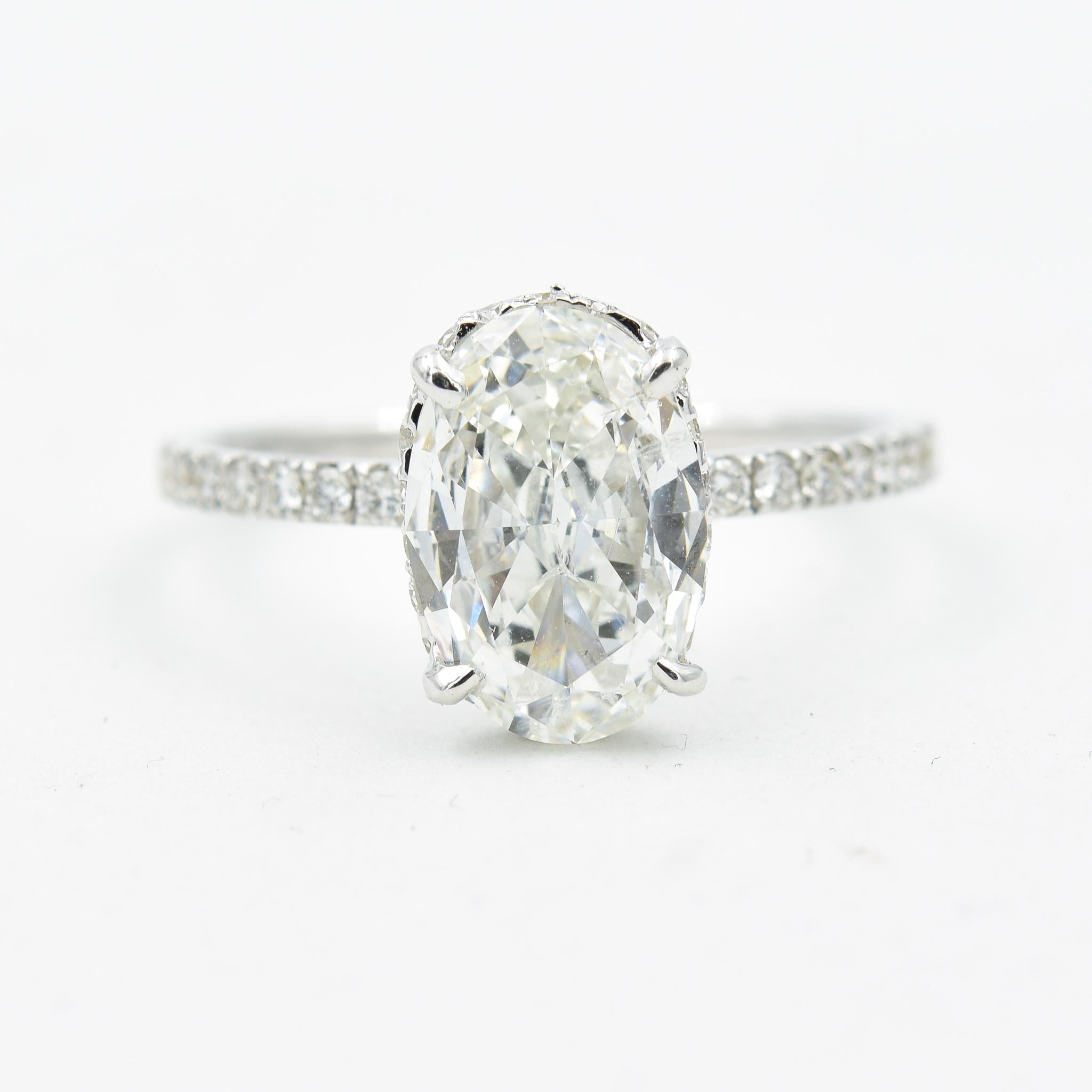 18k White Gold
Finger Size: 6.25
Diamond Qualities:	G color I1 clarity
Diamond Weight: 1.51ct
Diamond Shape: Oval