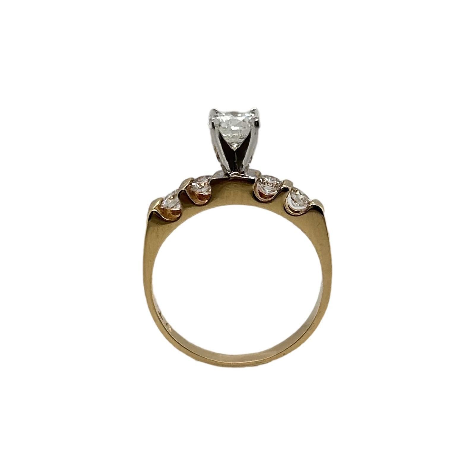 Beautiful engagement ring set in an 18k yellow gold setting. A super clean and nice center stone with 2 diamonds on each side to complement the center piece.

Ring size: 5.25 (Sizable)
Stones: Natural Diamonds
Center Stone: 0.9 carats
Side Stones: