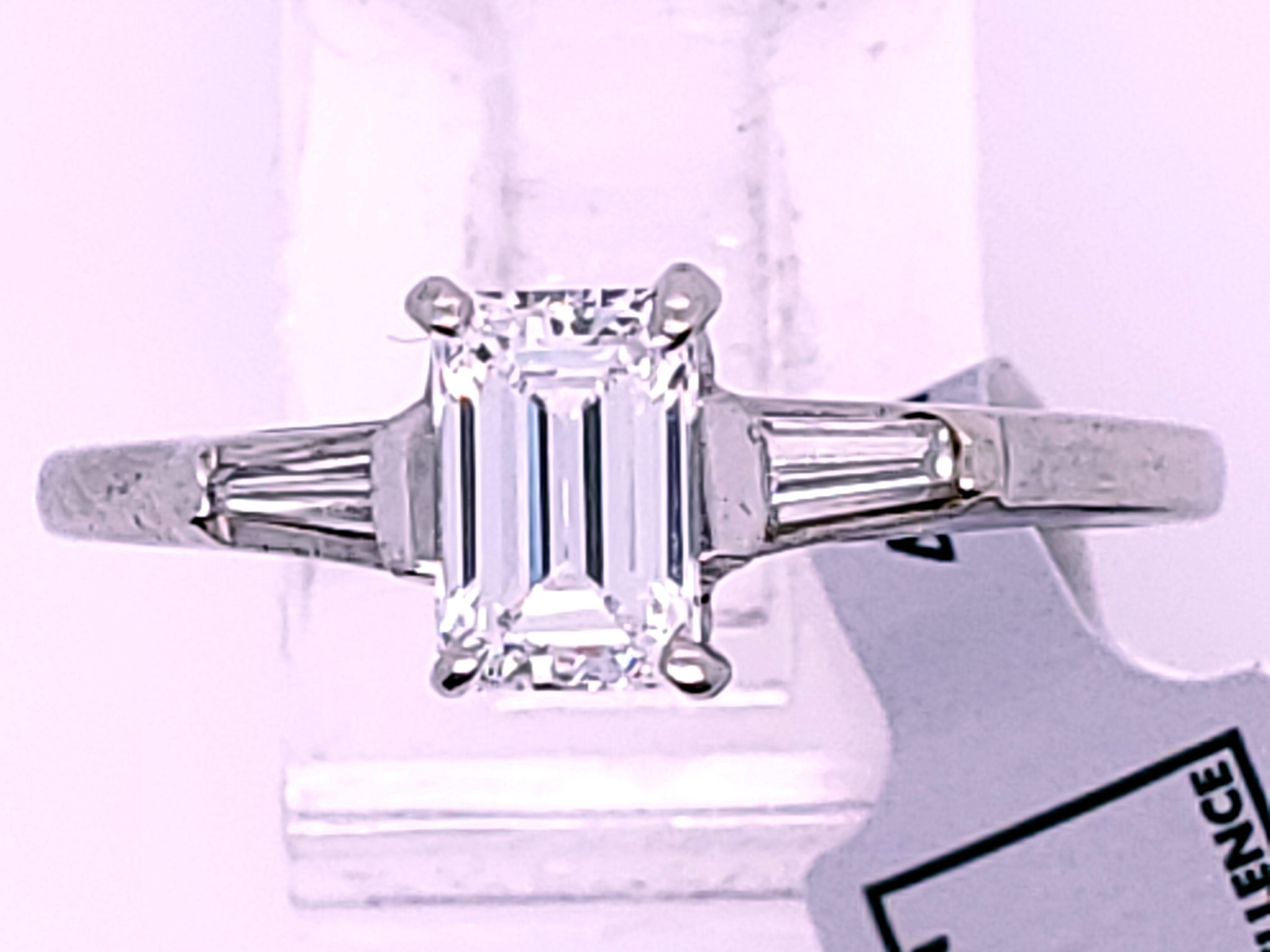 Platinum Ring containing an approx 65pt Emerald Cut Diamond, of VS clarity and color of H/I; flanked by two tapered baguettes approx 7+pts each totaling 15pts also of VS clarity of near colorless.  Stamped 10% Irid Pt.  Ring is certed by IGI in NYC