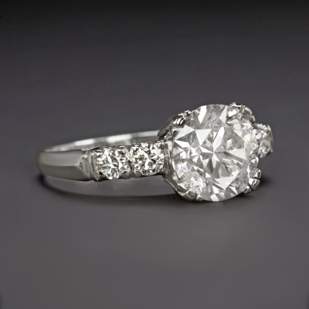 This stunning and classic engagement ring of 2.75 carat with an extraordinarily large 2.50 carat central diamond is beautifully 100% natural white, with no treatments or enhancements of any kind. Exceptionally well cut, it displays fantastic