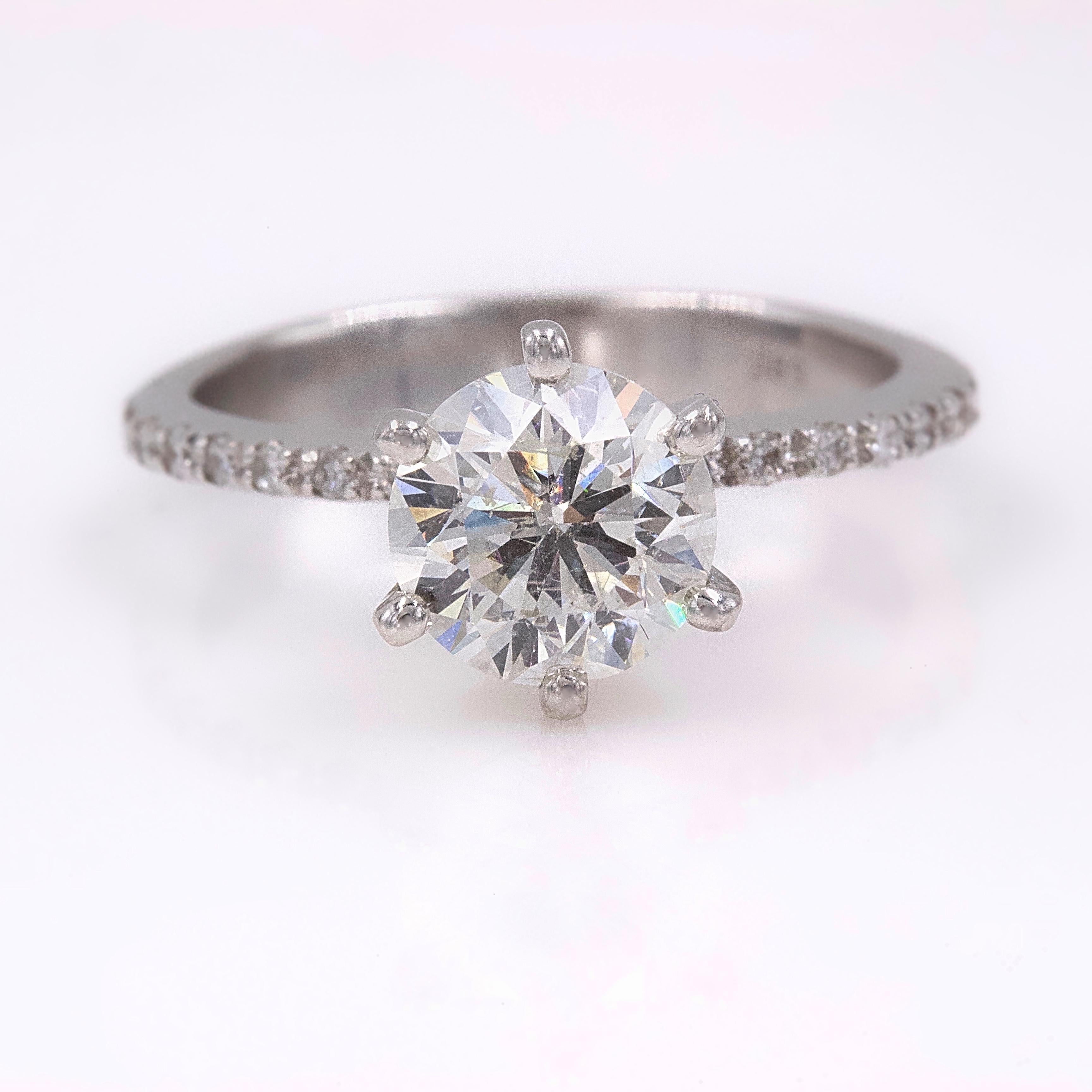 DIAMOND ENGAGEMENT RING

Style:  Solitaire with Diamond Band
Serial Number:  BB10010
Certification:  IGL 6798464
Metal:  14K White Gold
Size:  6.75 - sizable
Total Carat Weight:  1.74 tcw
Diamond Shape:  Round Brilliant Cut 1.64 ct Ideal Cut
Diamond