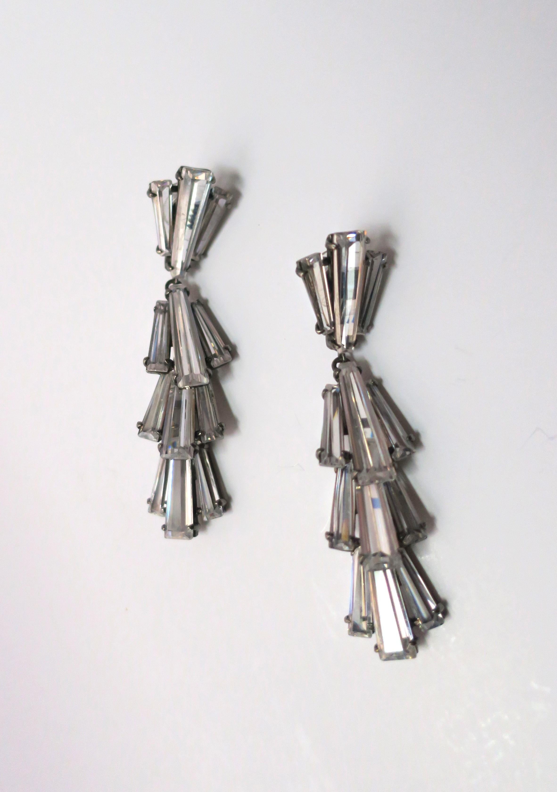 A gorgeous pair of diamond-like crystal dangle earrings by Jarin. Beautiful baguette cut crystals set in rhodium plate over sterling silver, circa early-21st century. With makers' mark 'JARIN' on back. A beautiful pair, dress up or down. Excellent