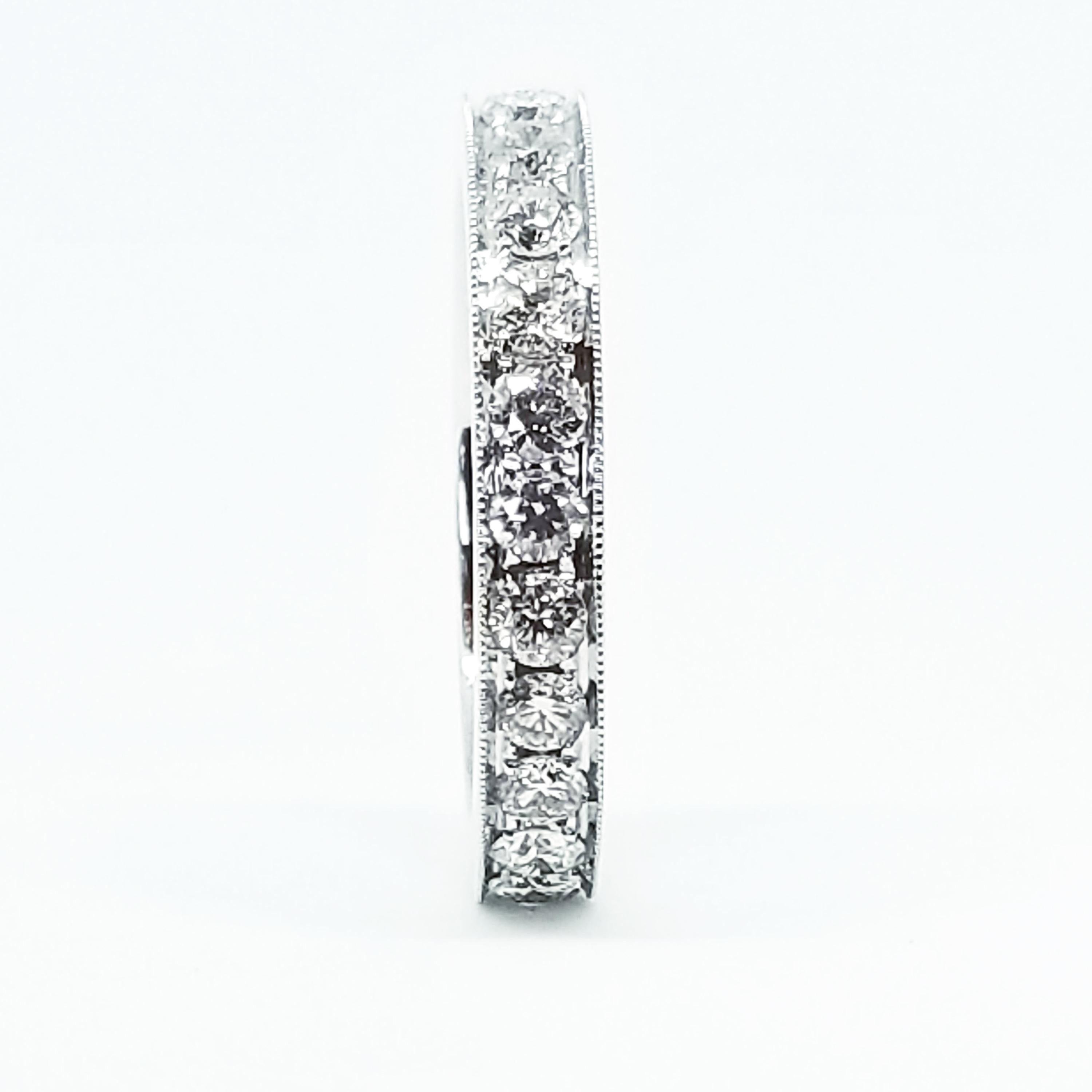 A Classic Round Brilliant Diamond Eternity Ring features twenty-five Round Brilliant Diamonds of 1.41 Carats total weight set entirely around the band. The White Diamonds are of G Color and Si1 Clarity. The Band features an open work inside, highly