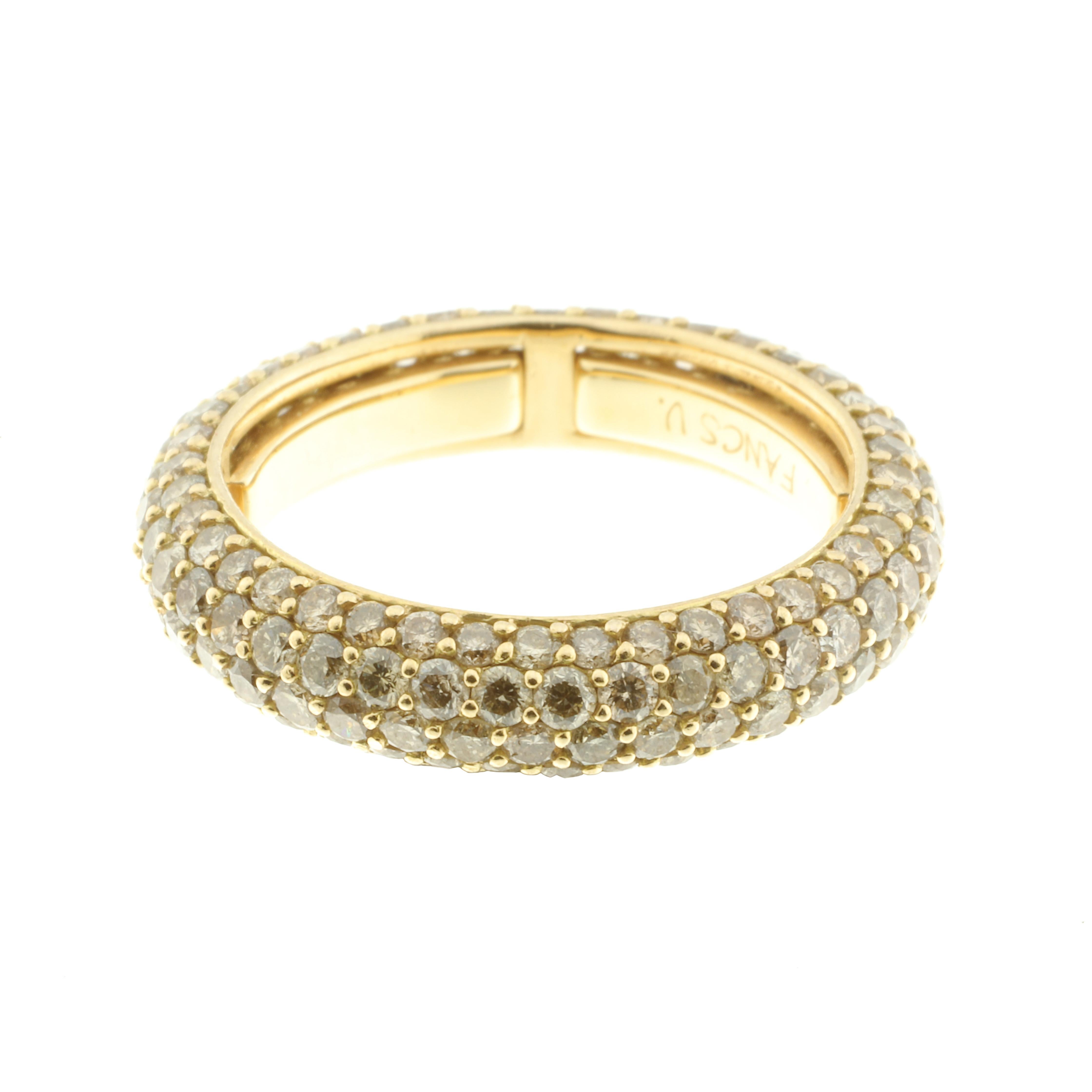 An 18-karat yellow gold and 3.08-carat brown diamond ( a beautiful champagne colour) eternity ring. 

A series of sprung sizers inside the band comfortably fit the ring to your finger. The ring looks beautiful alone or as the crown jewel stacked
