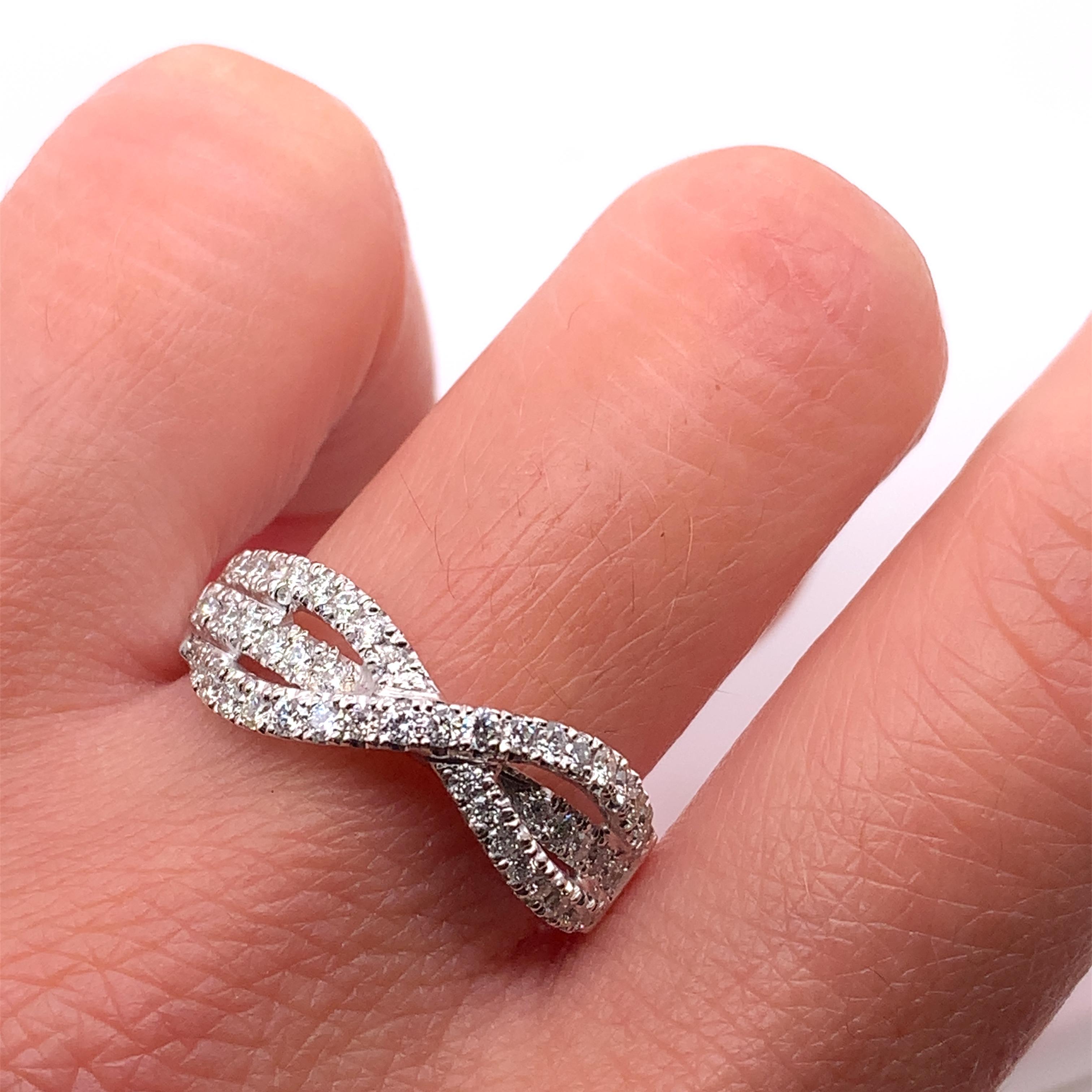 Round brilliant diamond twisted pave setting engagement ring wedding band in 18ct white gold.
Weight 5.2g
Diamond total weight 1.00ct F VS1.
Ring can be resized
Width 7mm upper
Box and valuation included

This stunning 1.00ct diamond eternity
