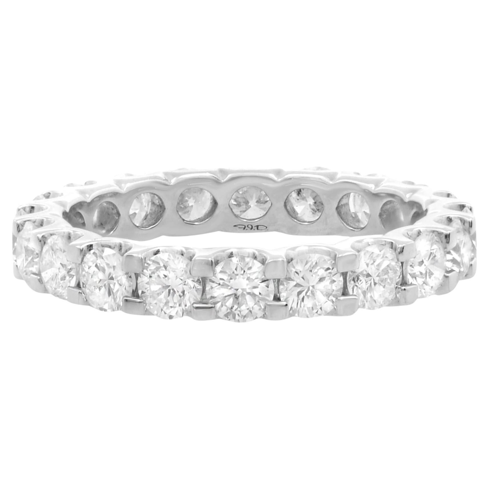 Eternity wedding band with shared prongs holding every stone in. With a total of 2 carats, each precious round diamond dances gleefully in the light, completely individual and yet tied together happily for eternity in white gold. The ring weighs 6.0