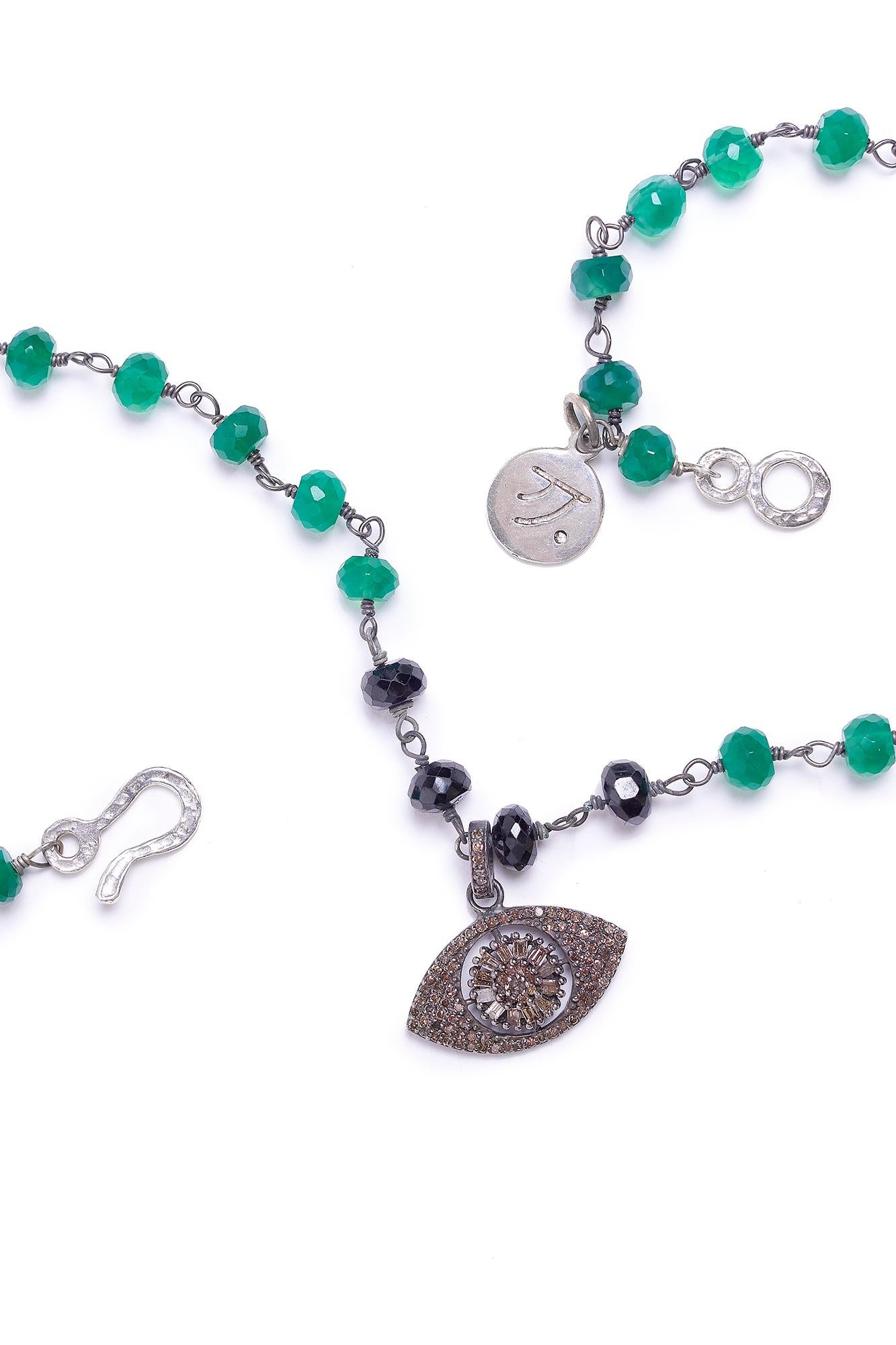 Properties
Evil Eye is a prominent symbol in the Moroccan culture. The necklace is adorned with rich deep green onyx stones.  The necklace is accented with a brilliant pave diamond evil eye.

Materials
Green Onyx, Black Onyx, Pavé Diamonds, Sterling
