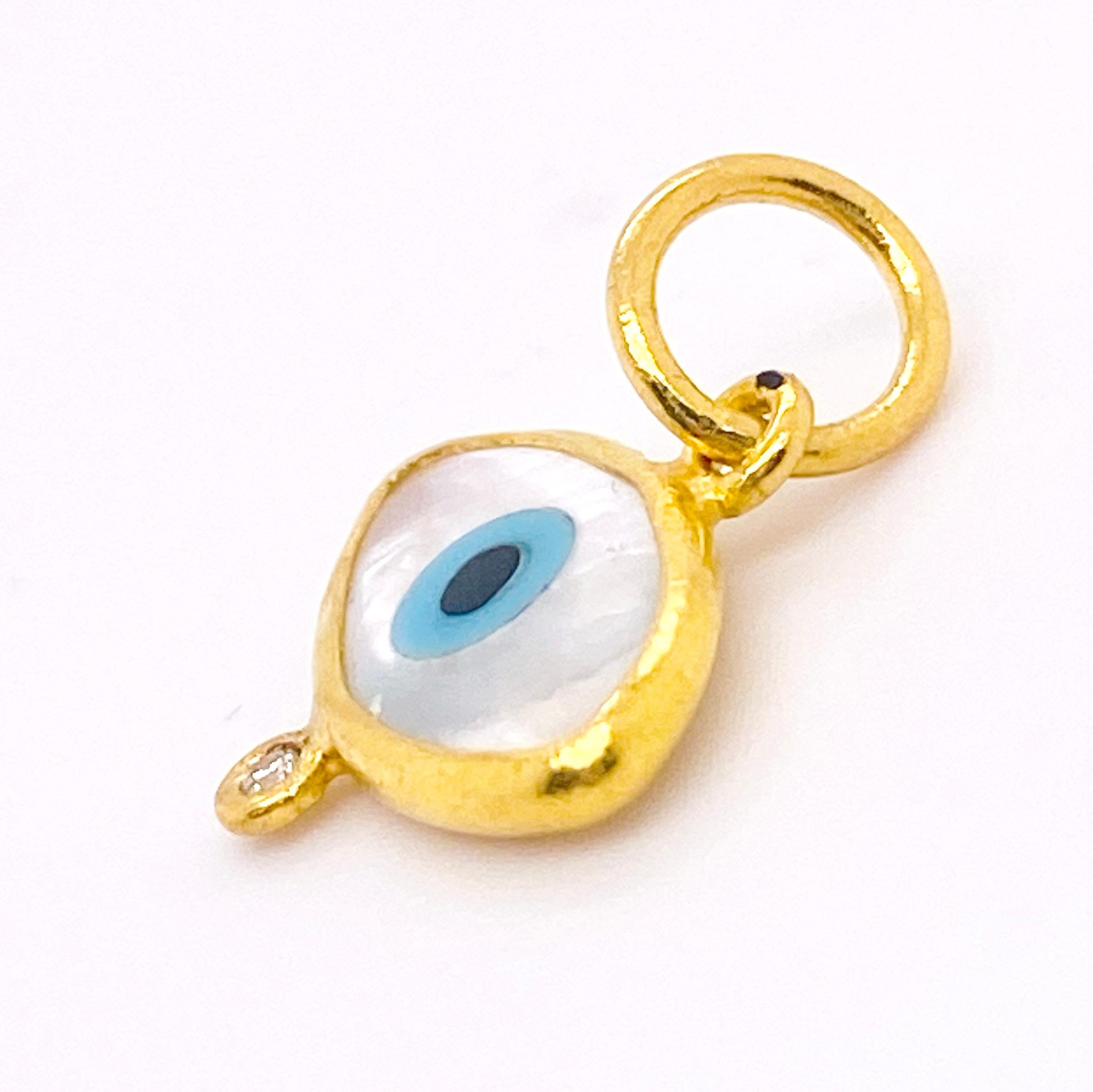 The evil eye will protect you from all evil! Made in solid 24 karat gold with genuine mother-of-pearl with a bezel set, genuine, natural diamond. This charm is large enough to wear as a pendant or small enough for a charm bracelet. The details for