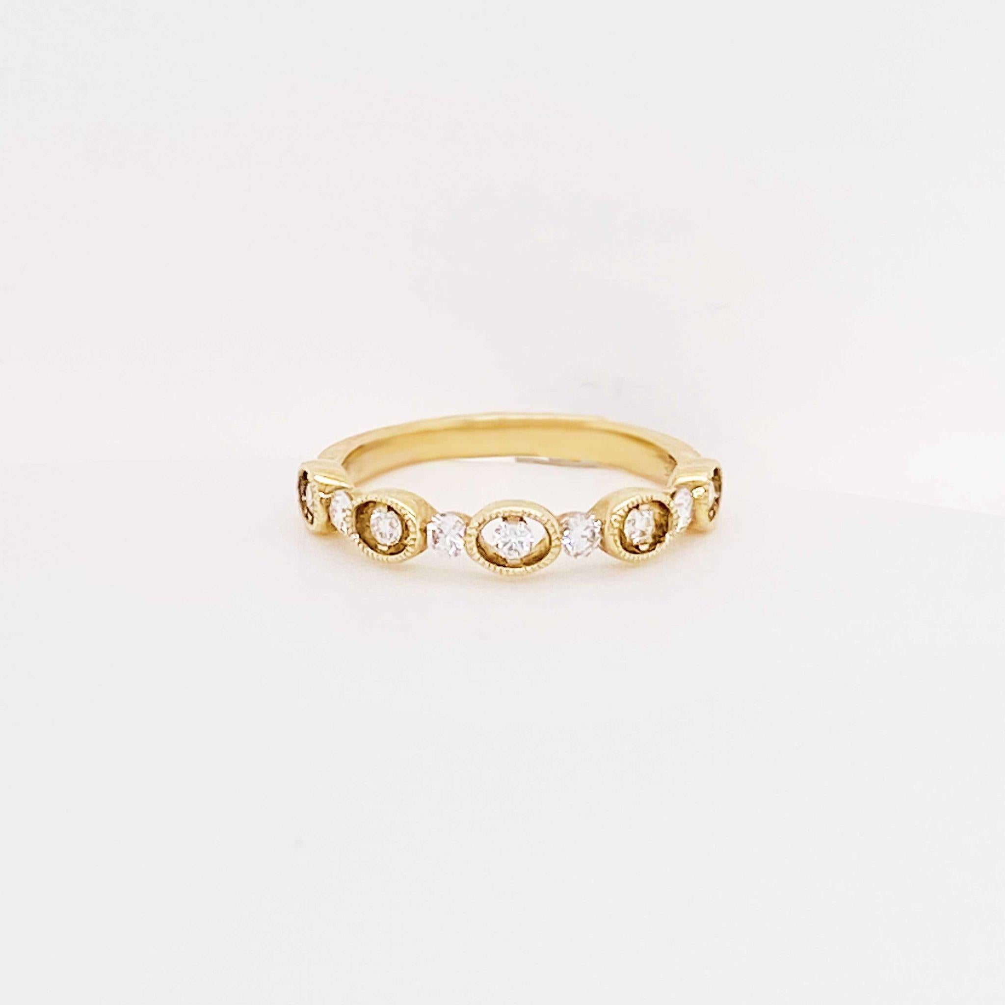Diamond wedding band with modern design! This unique diamond band has round brilliant diamonds set in oval bezel frames with round brilliant diamonds set in between each frame. The diamond band has a design that goes half way around the ring. This