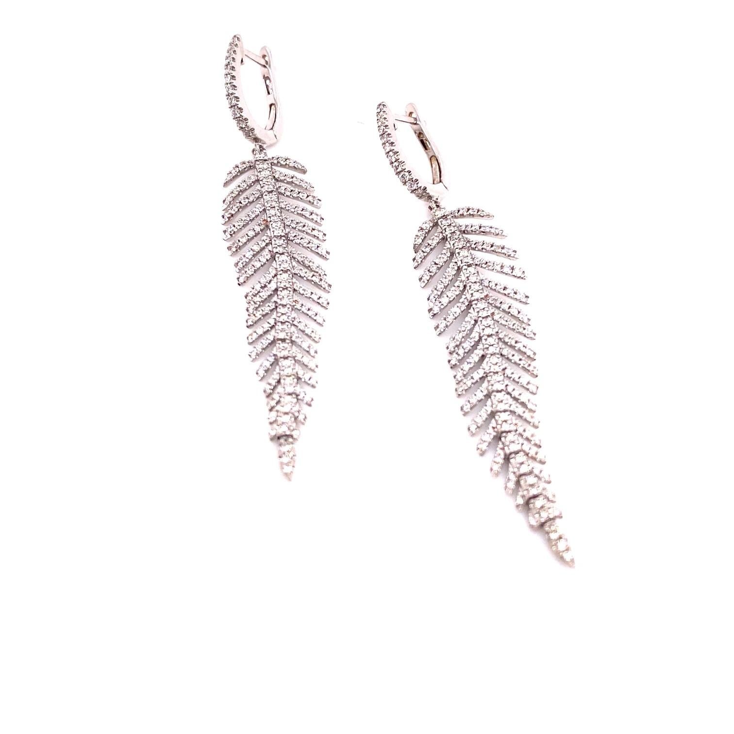 18k Gold Diamond Feather Earrings 

These exquisite earrings sparkle with diamonds, and is constructed meticulously to create a smooth movement in its design. High quality earrings crafted in 11.75 grams in 18k white gold, and has over 360 round