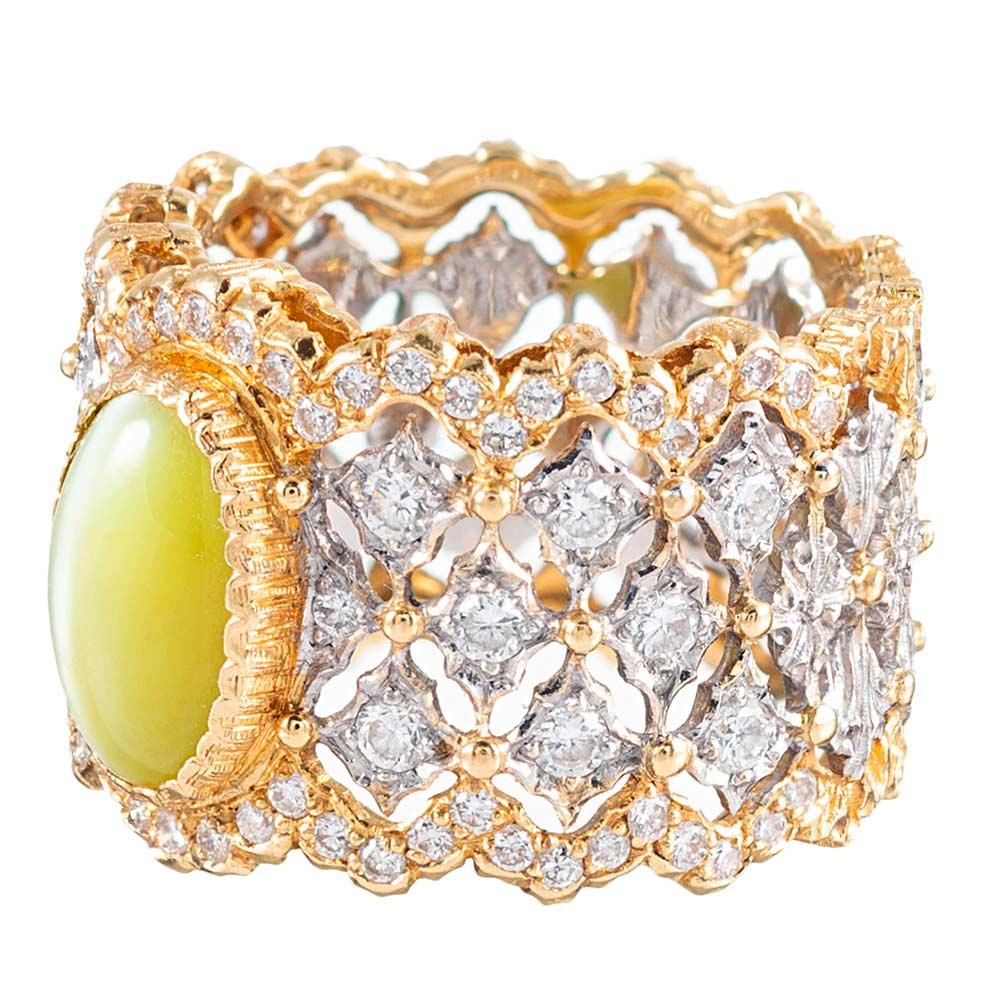 Buccellati’s incredible goldsmith technique is distinct, striking and absolutely beautiful. The present piece is unusual, the classic wide eternity band rendered in 18 karat white and yellow gold, but set in the center with a cabochon of cat’s eye