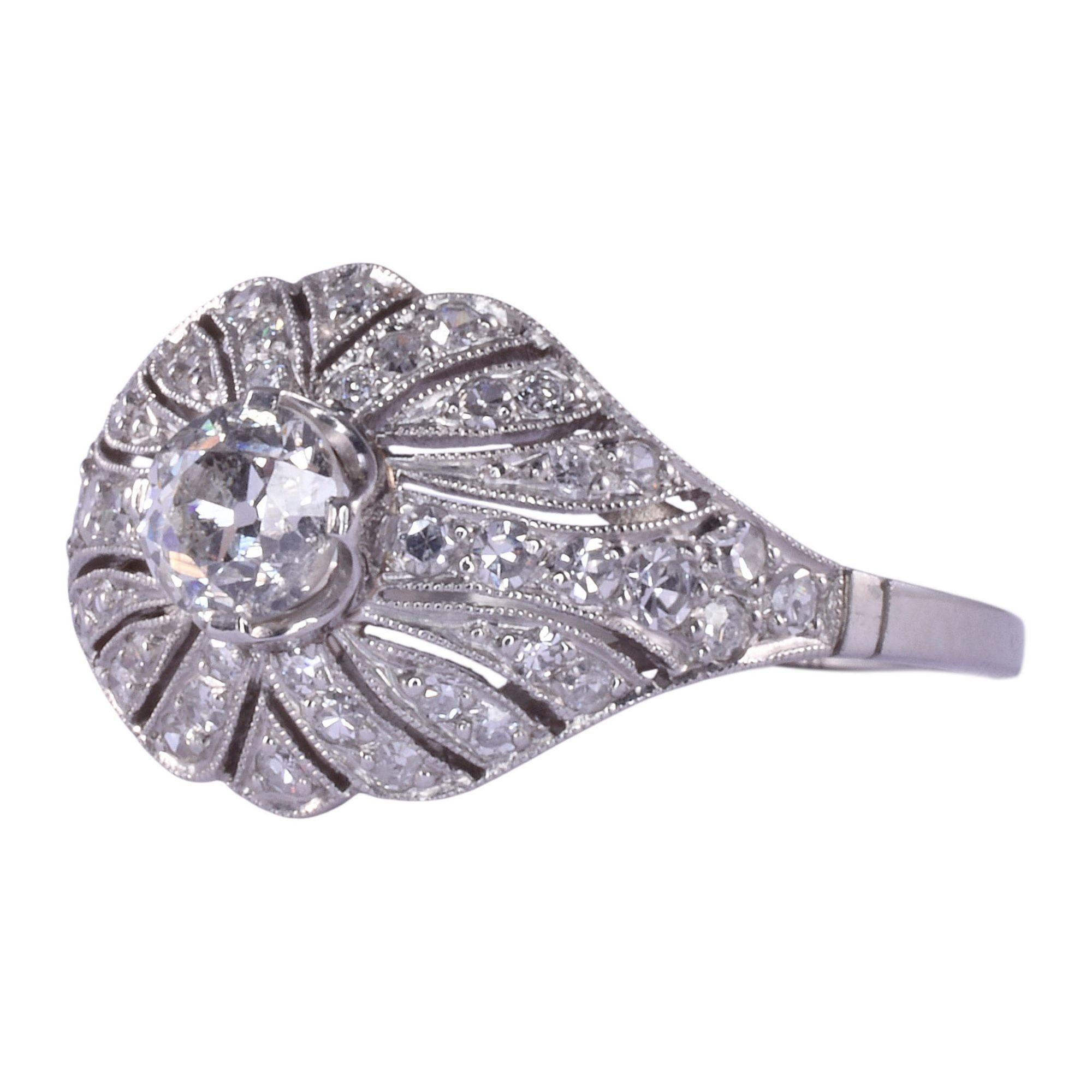 Antique Edwardian diamond filigree platinum ring, circa 1915. This antique filigree ring is crafted in platinum and features a .41 carat old European cut center diamond. The diamond has SI2 clarity and J color. This platinum ring also has single cut
