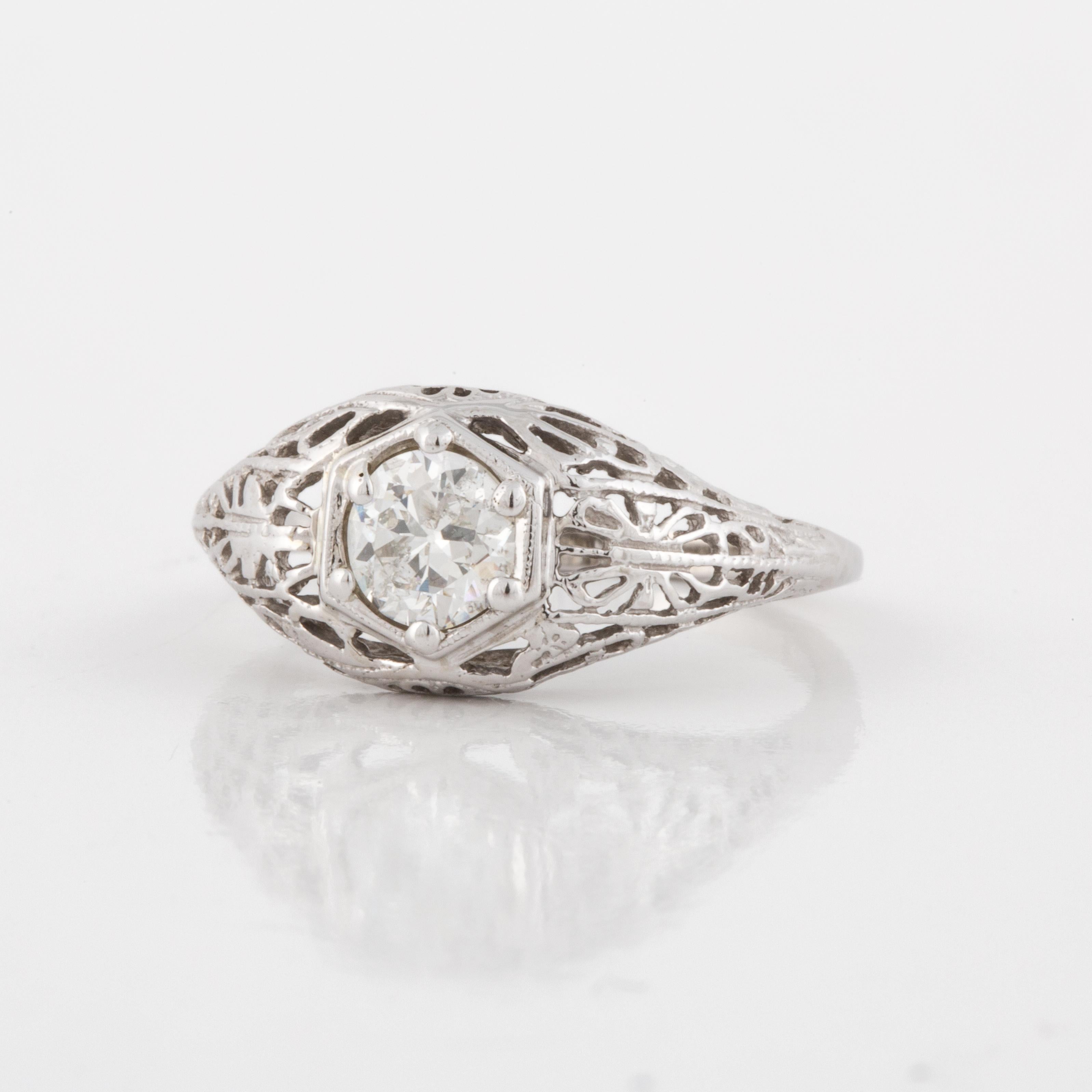 14K white gold filigree ring from the 1920's.  Filigree work is still in good condition with no loss or cracks.  Diamond is an Old European Cut weighing 0.55 carats; it is G-H in color and SI2-I1 in clarity.  Measures 5/8