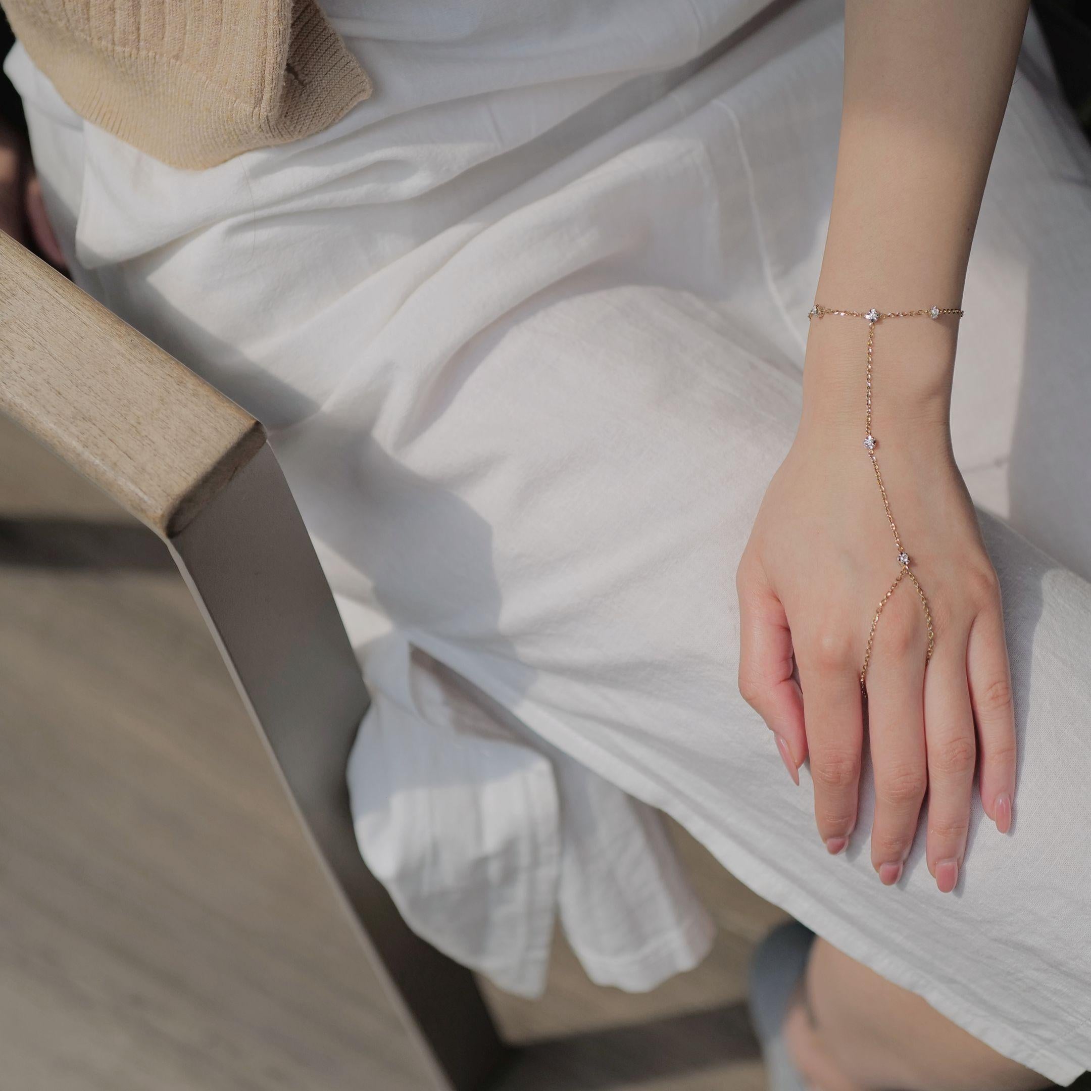 This gorgeous bracelet is the perfect accessory to elevate your summer outfits. Crafted from luxurious 18K rose and white gold, it features a single dazzling round brilliant cut diamond prominently displayed at the front of the bracelet. Surrounding