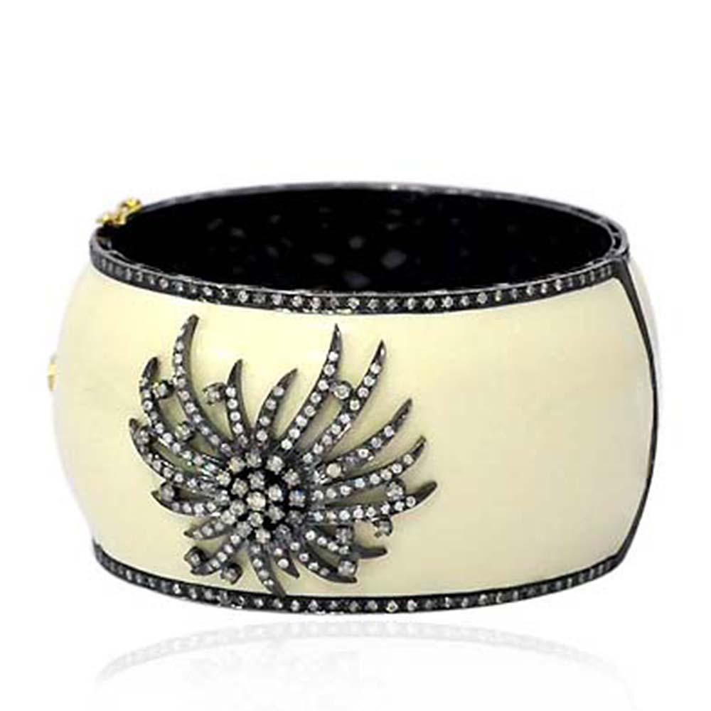 Pretty diamond firework motif on cream color enamel bangle bracelet is lovely and fits very nicely on the wrist. This bangle is openable with silver grill inside.

Closure: Box clasp with safety lock

18kt: 3.8gms
Diamond: 3.61cts
Silver: 80.9gms