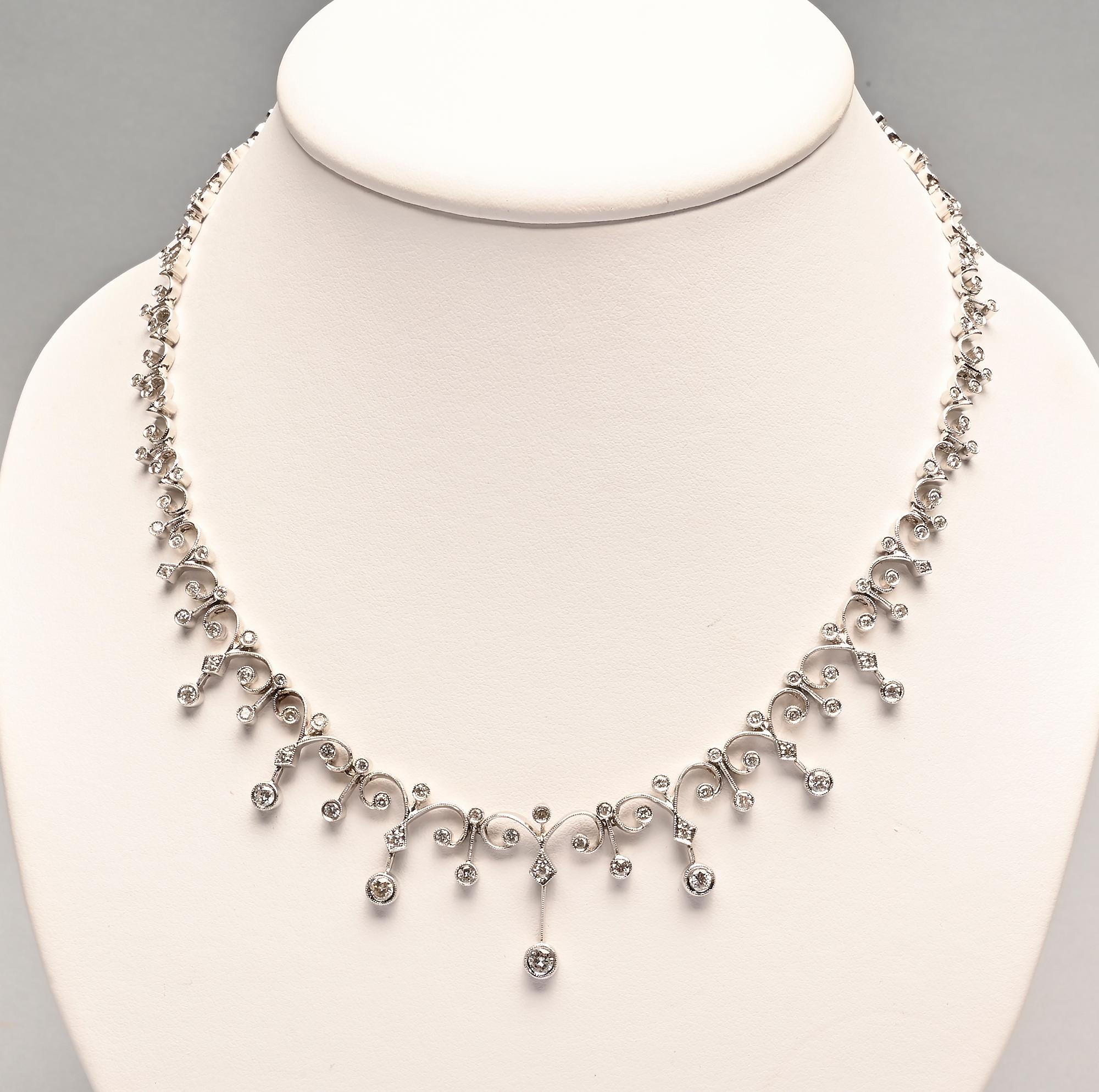 Delicate and graceful diamond necklace with curved links much like a fleur de lis. The central links have graduated pendants. The necklace is 18.5 inches long; made of 18 karat white gold.
Truly a stunning piece of artistry.