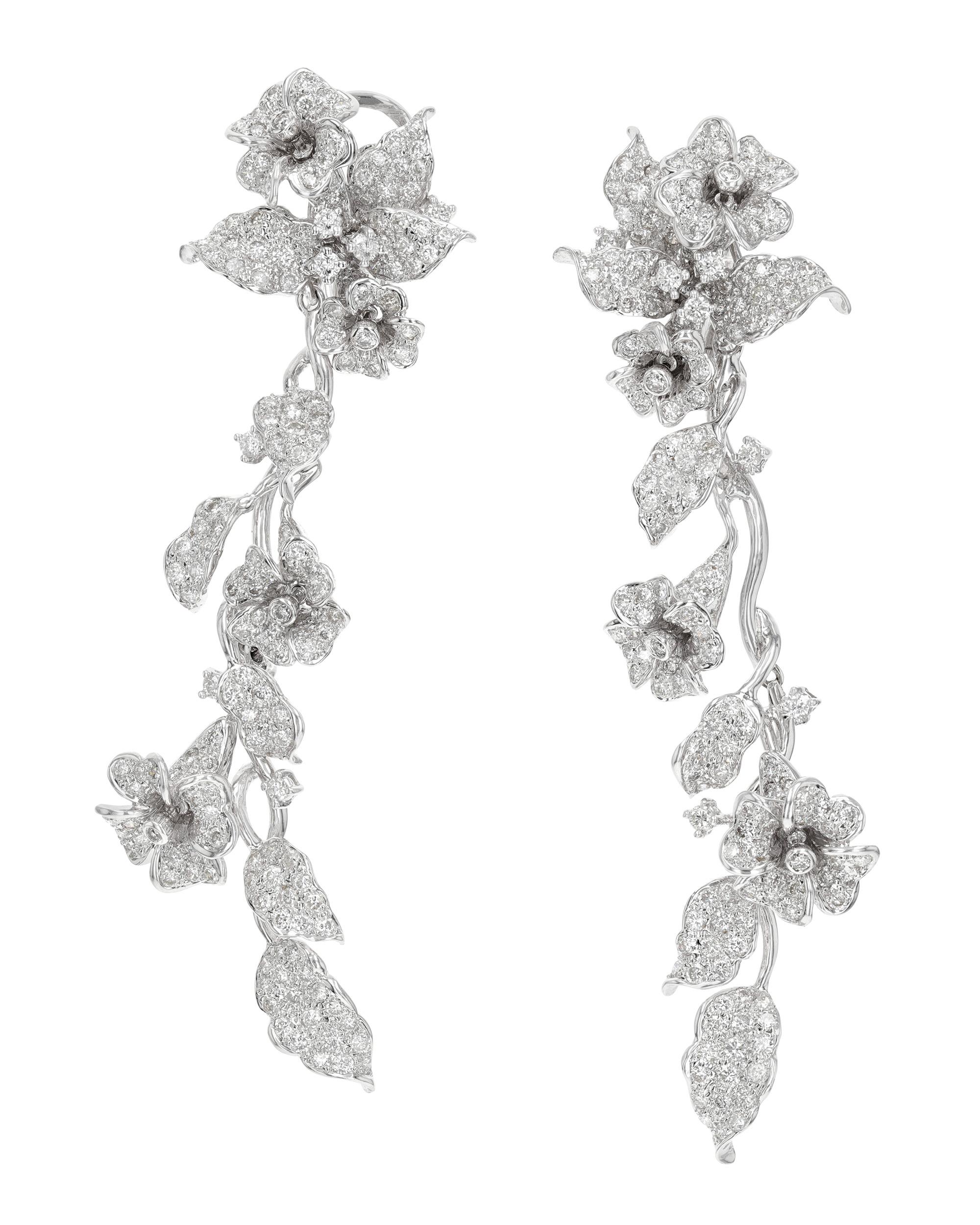 These romantic and elegant floral earrings evoke the beauty of springtime year-round. Diamonds totaling approximately 7.35 carats form the flowers and foliage, lending ample sparkle to the organic design. The dangling vines are detachable, providing