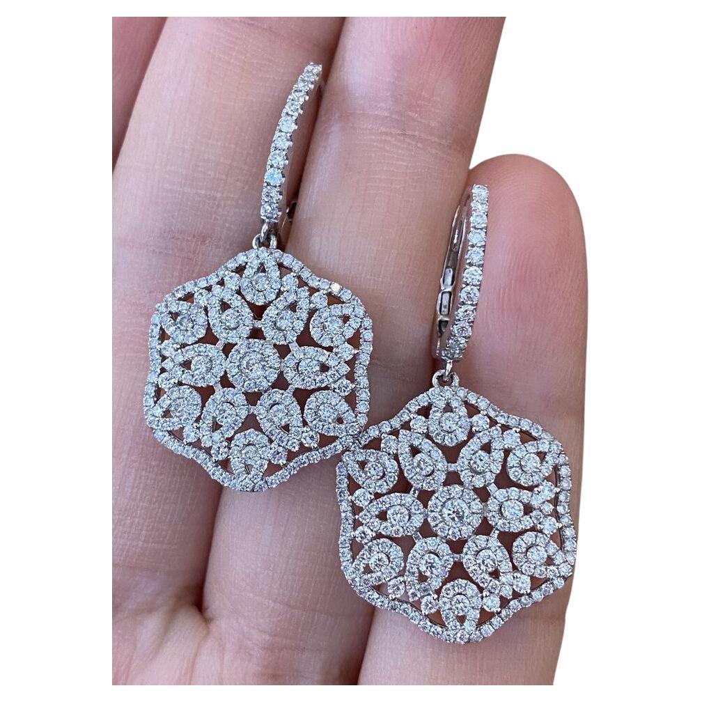 Diamond Floral Dangle/Drop Earrings 2.45 carat total weight in 18k White Gold

Diamond drop Earrings feature a large Circular Design with 2.45 carats of Round Brilliant Diamonds set in a floral pattern hanging from a single row of diamonds, all set