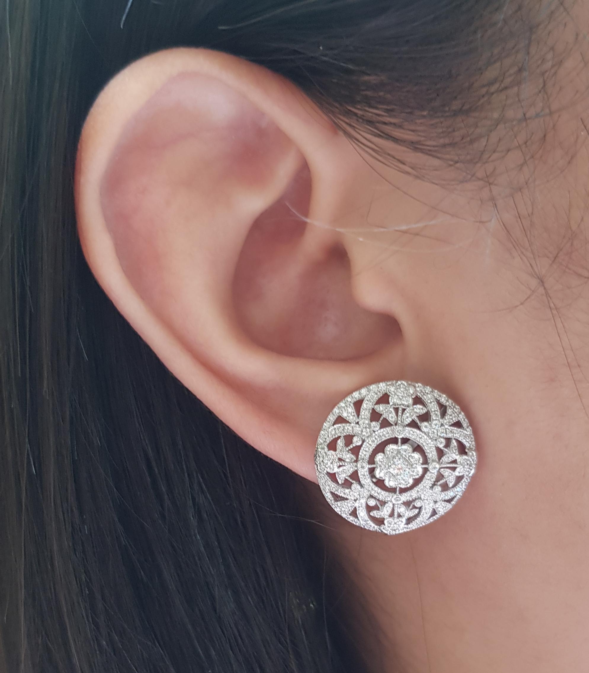 Diamond 0.74 carat Earrings set in 18 Karat White Gold Settings

Width:  2.0 cm 
Length: 2.0 cm
Total Weight: 9.68 grams

