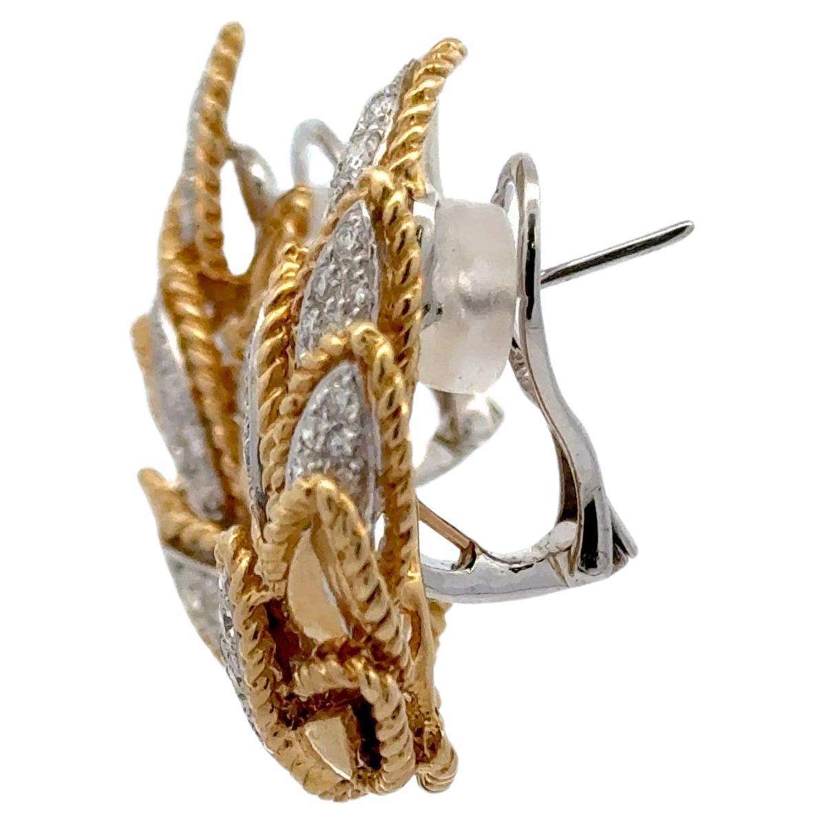 18 Karat yellow gold floral leaf motif earrings featuring 82 round brilliants weighing 2.19 carats. 
Color G
Clarity SI