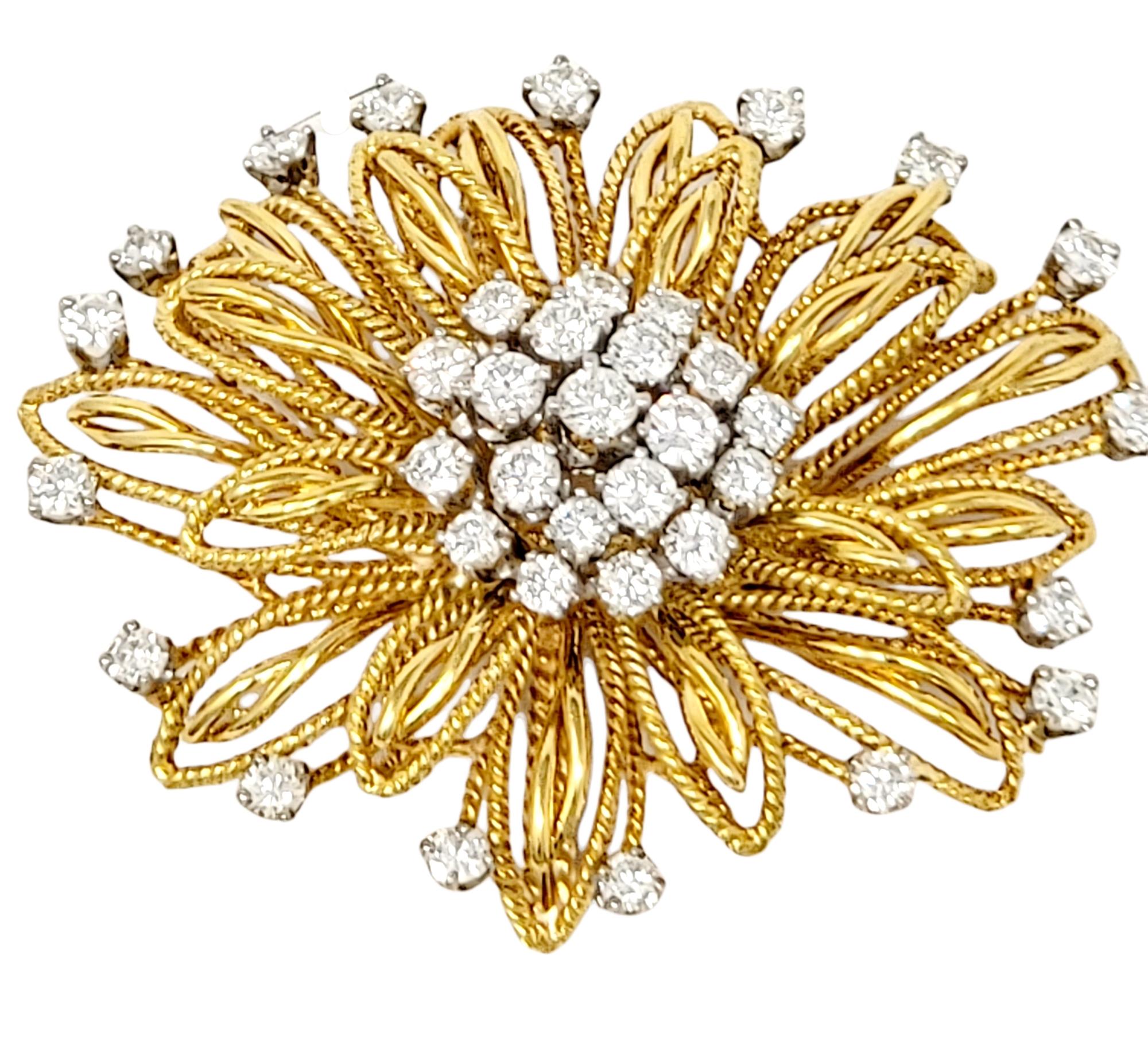 Absolutely gorgeous diamond and 18 karat yellow gold flower motif brooch. This beautifully textured piece is accented by incredible sparkling diamonds that shimmer throughout. The exquisite brooch features multiple layers of delicate, open gold
