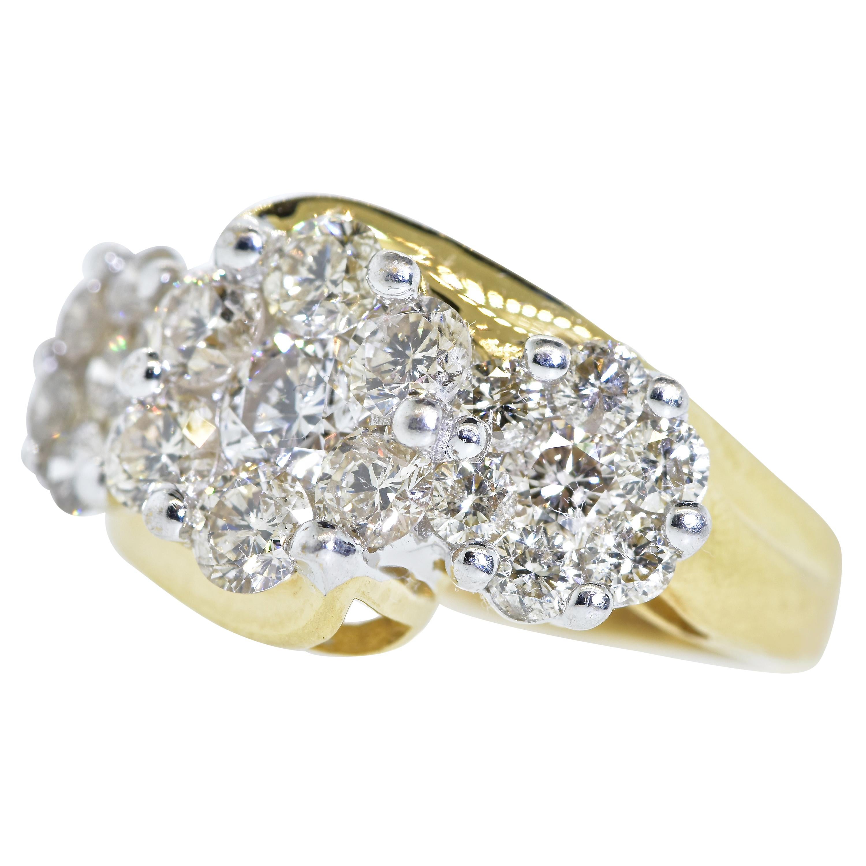 White diamonds are set in 3 floral motifs.  There are 2.5 cts. of round brilliant cut diamonds all are well cut and finely matched.  The 21 diamonds have fine symmetry, near colorless (H/I), and very slightly included (VS).  This contemporary ring
