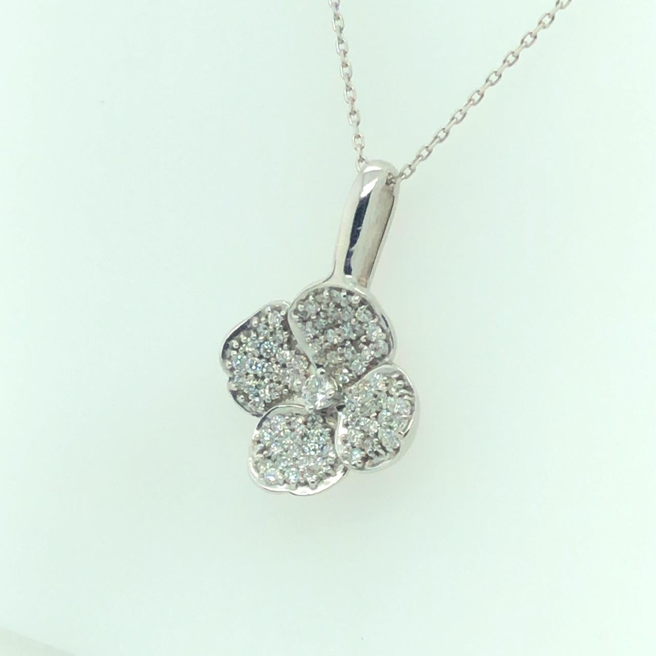 DIAMOND FLORAL PENDANT 18K WHITE GOLD

Total Carat Weight of Center Diamonds 0.08 carat

Micropave Round Brilliant Diamonds 0.77 carat

F/G Color VS Clarity

0.85 CTW of all Diamonds

With 16
