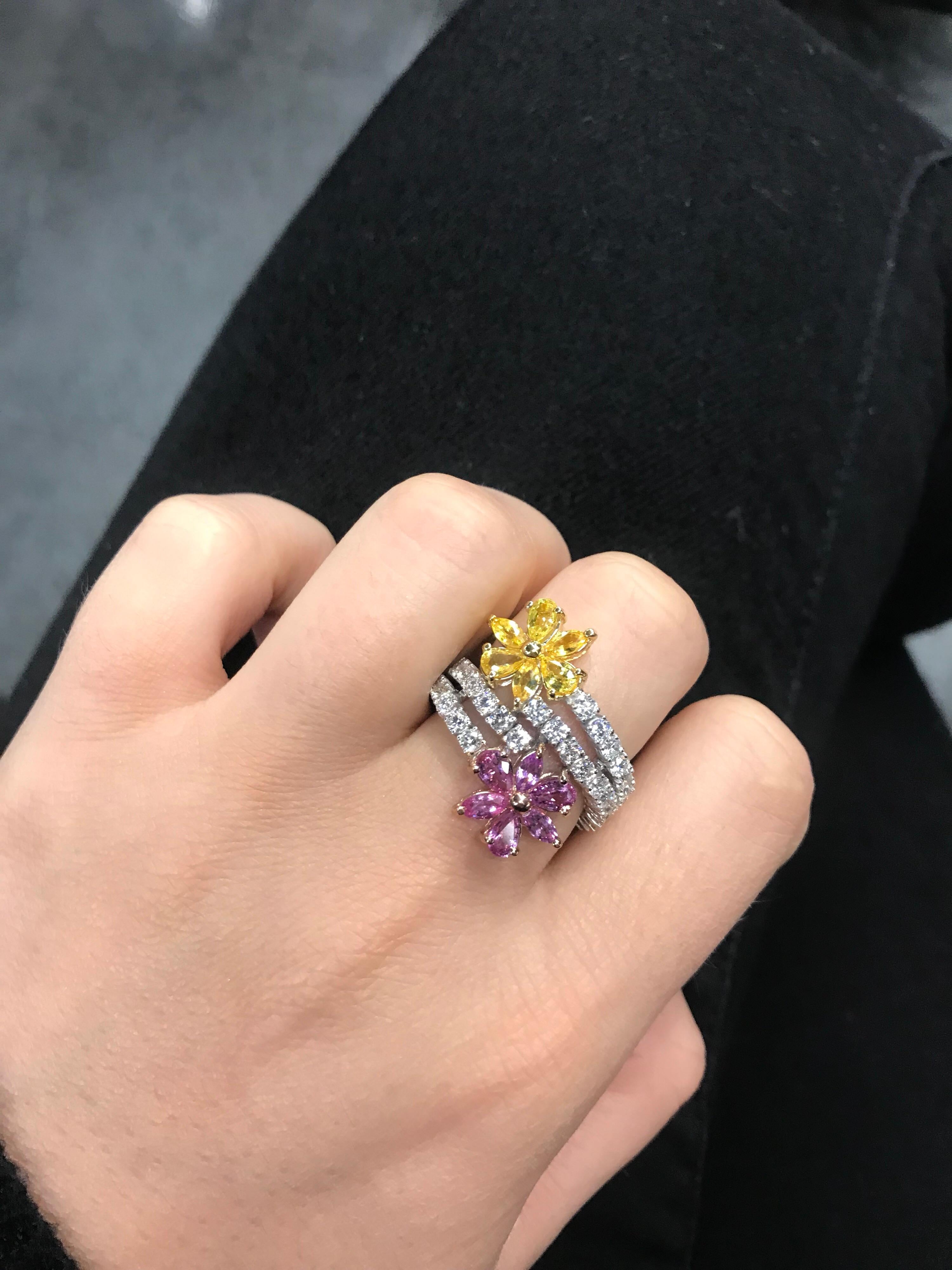 18k White gold ring featuring two pink and yellow floral motif sapphires weighing 2.68 carats on a flexible diamond wrapped band, 2.08 carats.
Color: G-H
Clarity: SI
Very comfortable on the finger! 
Can be customized to any gemstone.