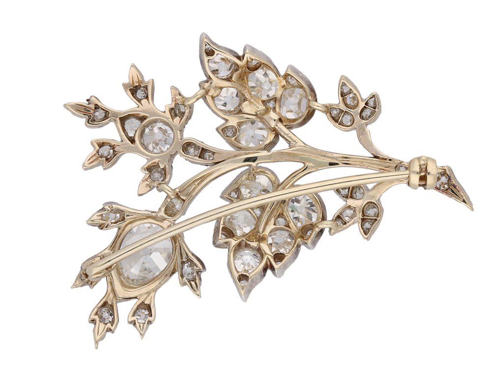 Diamond floral spray brooch. Set with one drop shape old mine diamond in an open back cutdown setting with a weight of 1.80 carats, and fifty one cushion shape old mine diamonds in open back cutdown and grain settings with a combined weight of 3.90