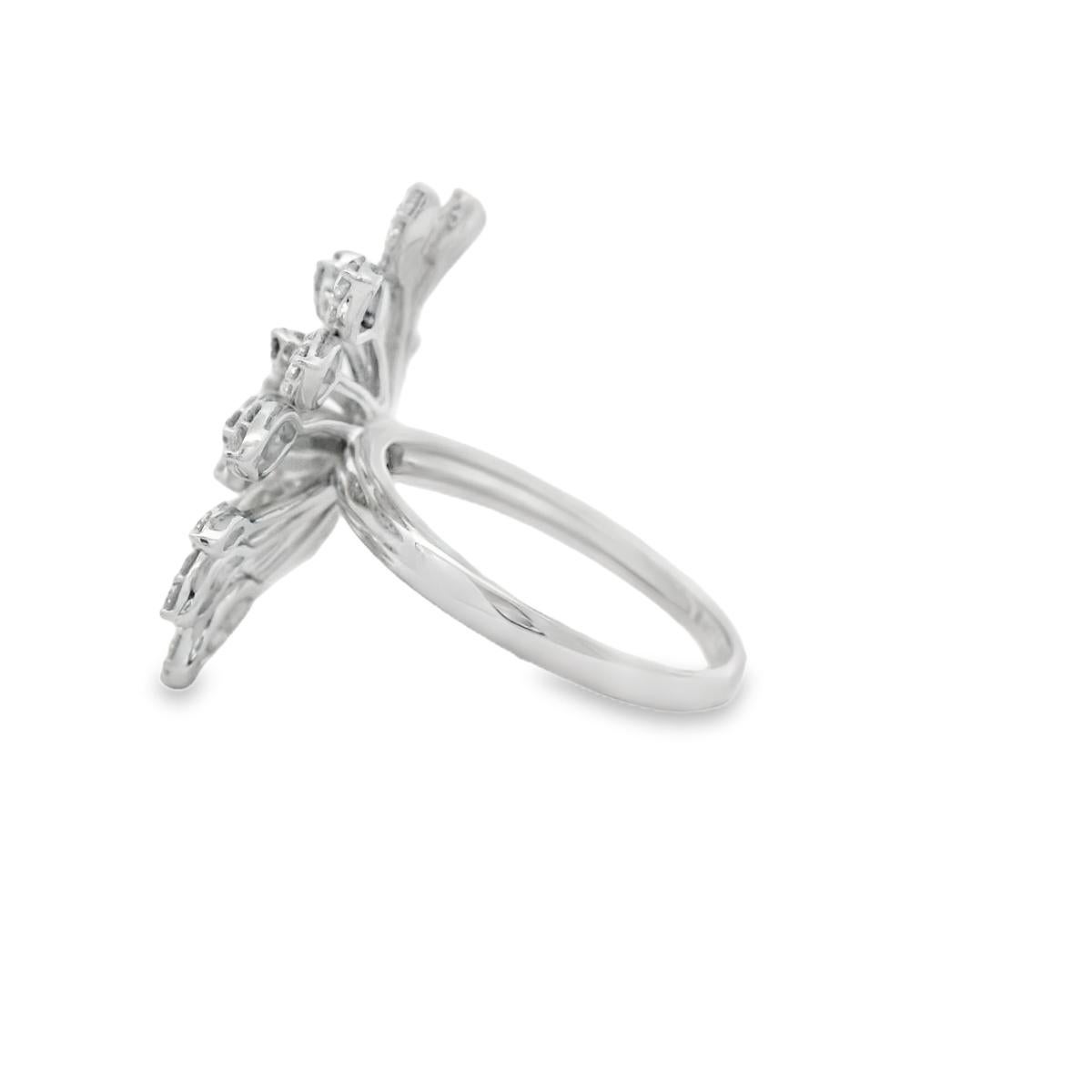 Sculptural and radiant, this diamond floral spray cocktail ring offers striking elegance in 14K white gold. Set with 107 round brilliant-cut diamonds totaling 1.33 carats, the design mimics the organic unfurling of petals or leaves in a dramatic,