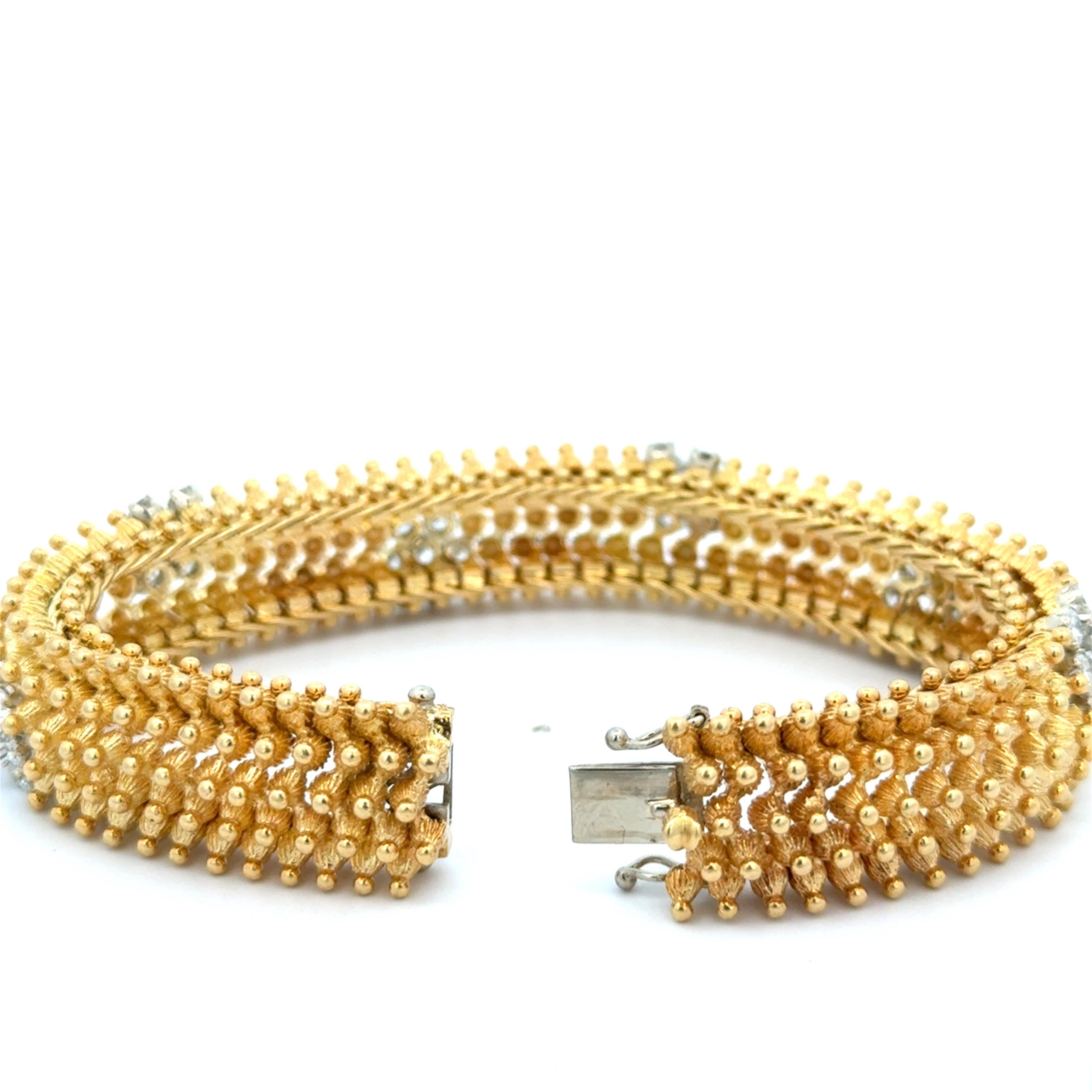 Diamond Florets Bracelet in 18K Yellow Gold. The bracelet features approximately3.40ctw of brilliant round diamonds. The bracelet is approximately 6.5 inches long, 0.50 inch wide, and weighs 77 grams.