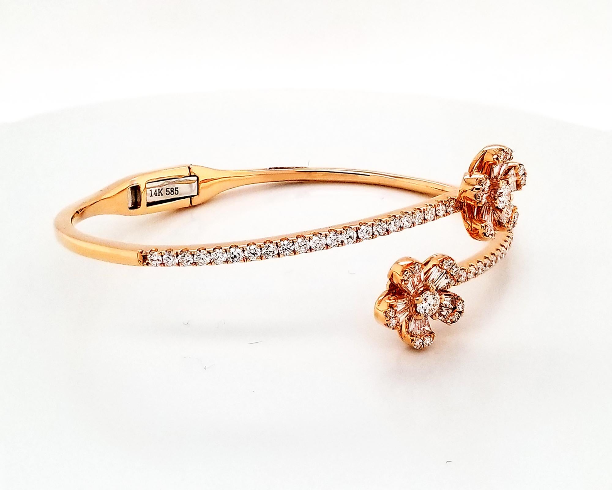 A beautiful bangle designed as two side by side flowers and embellished with invisibly-set diamonds.
20 baguette diamonds weighing 0.58 carats.
64 round diamonds weighing 1.19 carats.
Total diamond weight is 1.77 carats.
The diamonds are equivalent