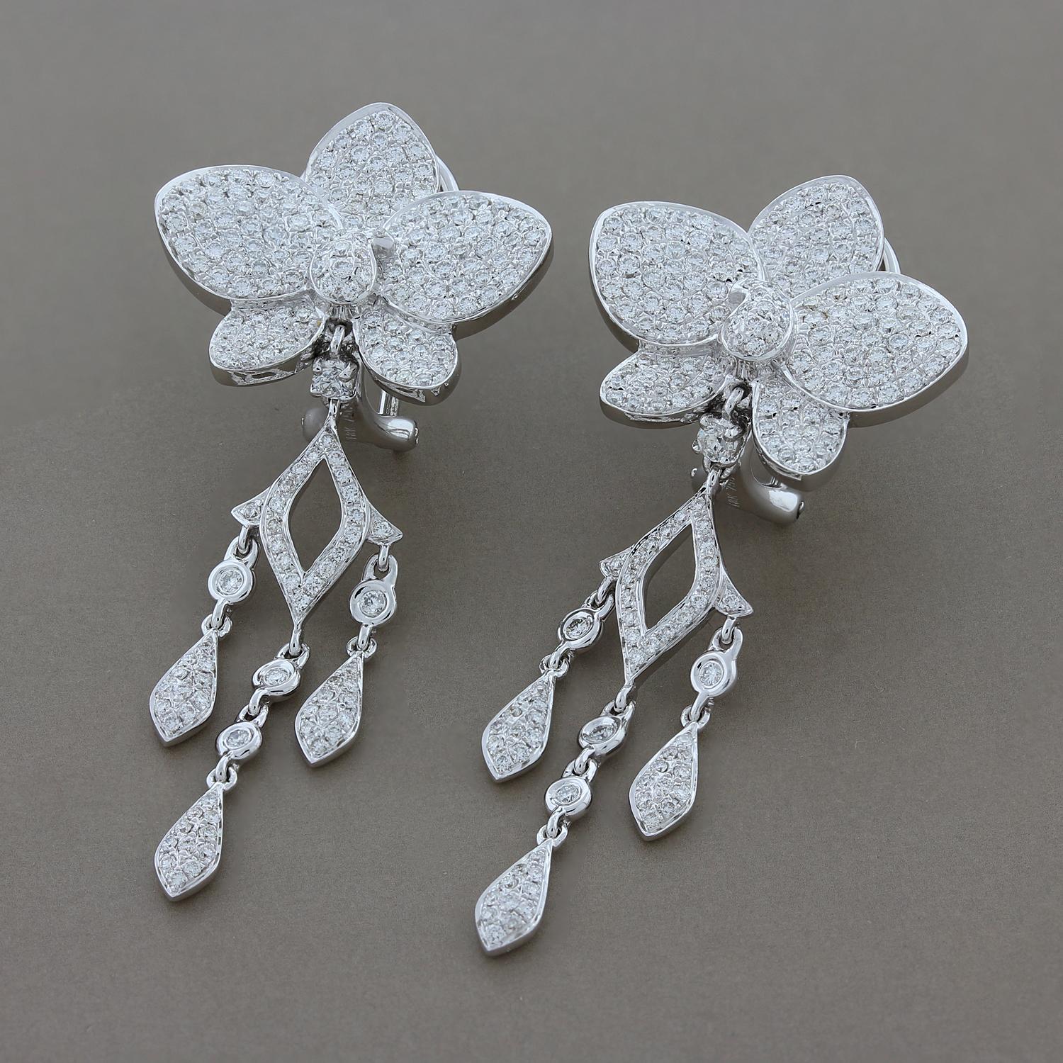 This pair of earrings features 2.40 carats of pave set round cut diamonds in an 18K white gold setting. The white diamonds are top VS quality with amazing shine. The flower and chandelier drop make this a feminine and fun pair of earrings to dance